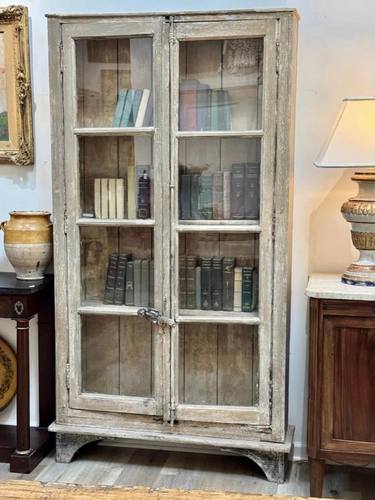 Bookcase cabinet made from early 19th C. reclaimed French windows, early wood, found in Provence.  The doors being French casement windows,  known as 