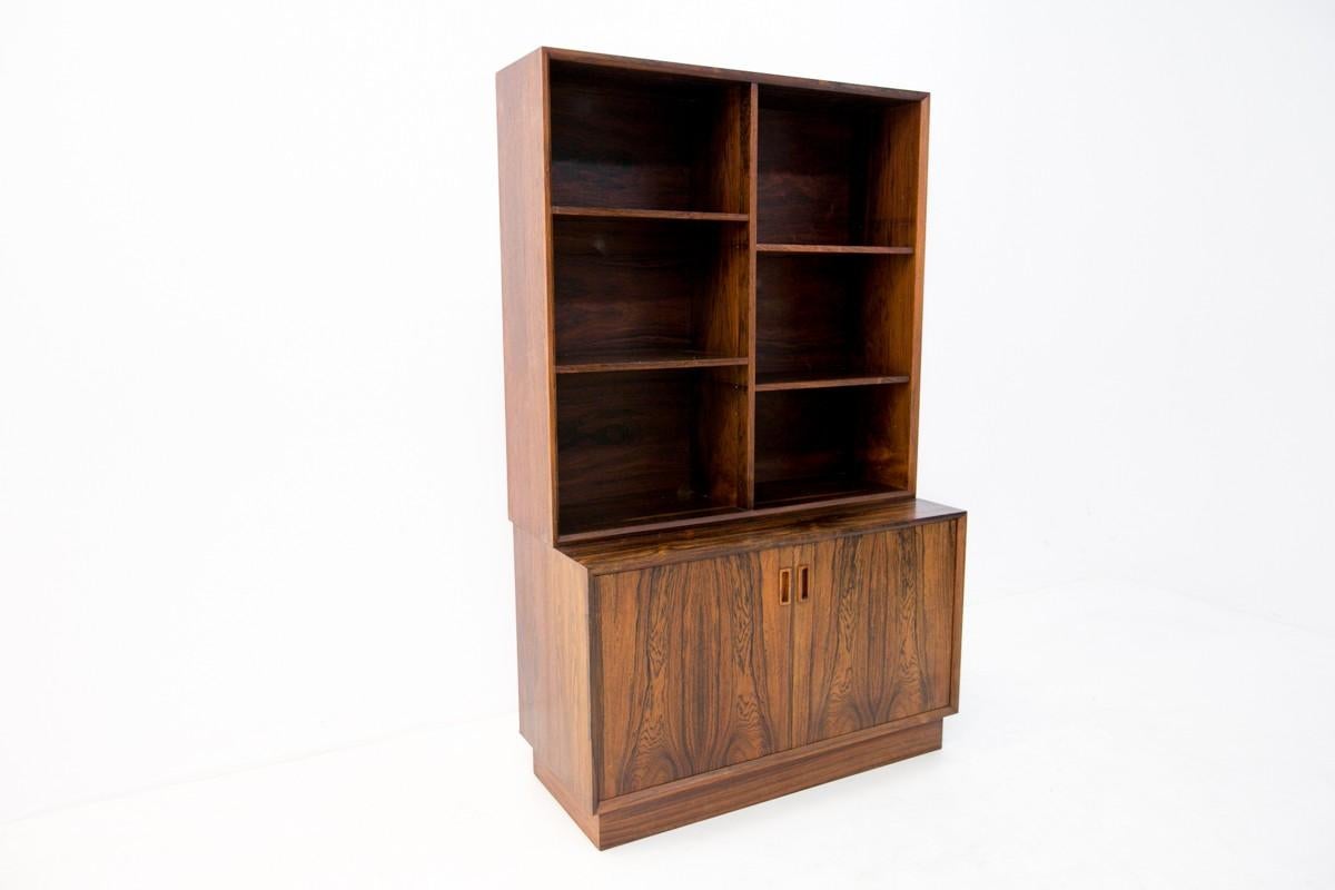 Bookcase - bookcase from the 60s. The furniture was made in Denmark.

The bookcase is in very good condition.

The upper part of the bookcase is open with many shelves. The shelves are placed at different heights, which breaks the look of the