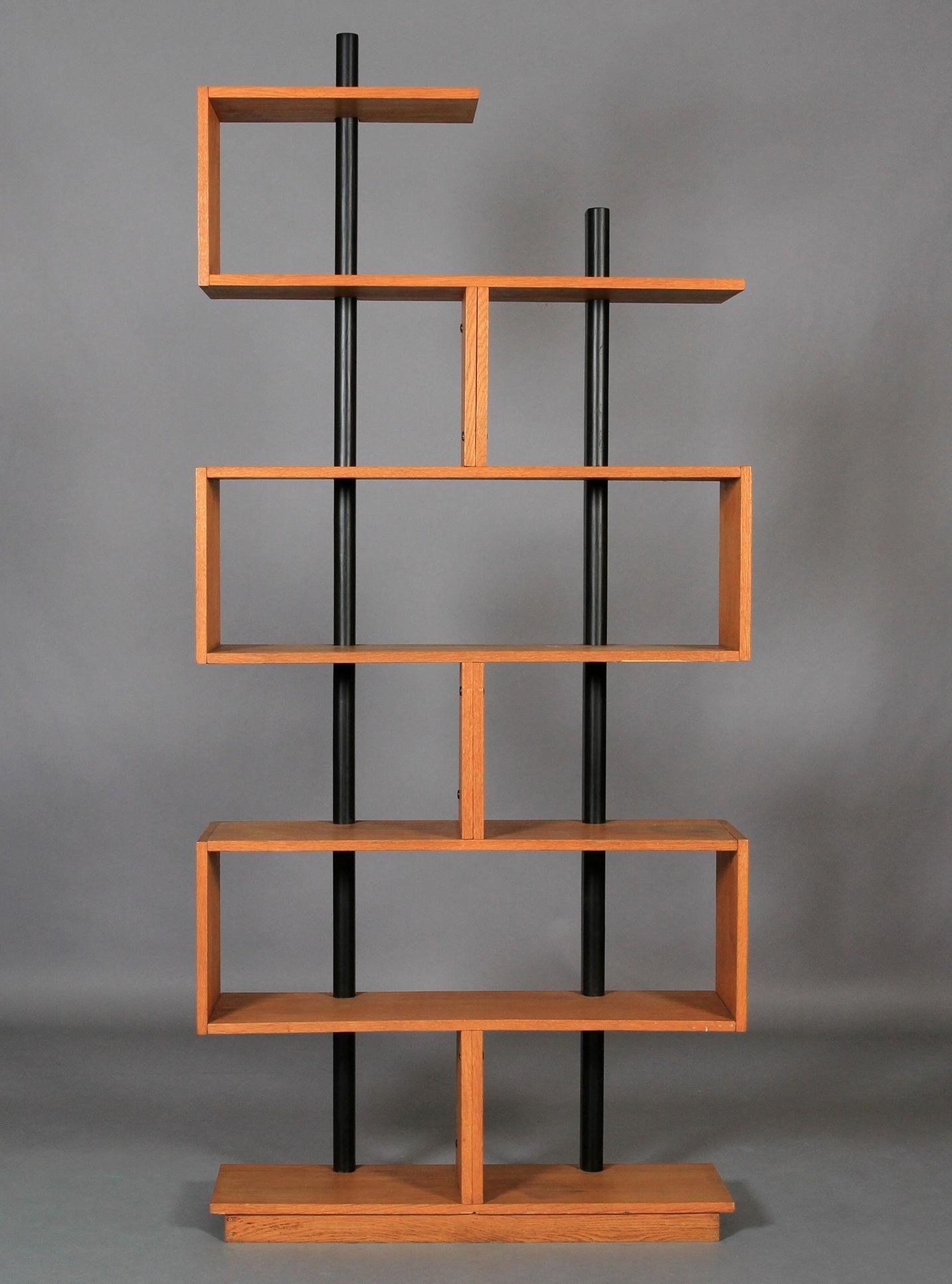 After Charlotte Perriand, freestanding teak and ebonized bookcase on a plinth base. Measures: L 3t 1