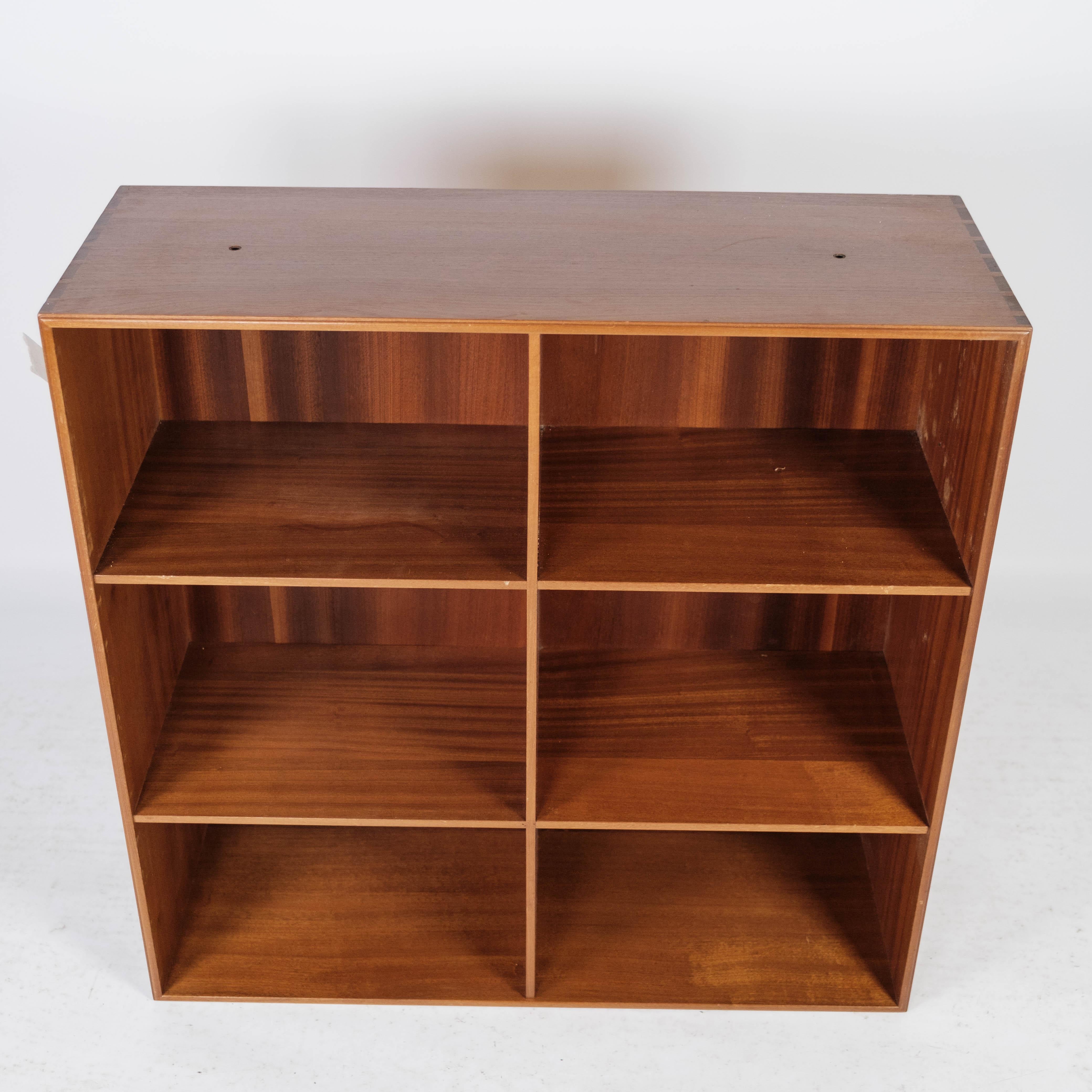 The light mahogany bookcase, designed by Mogens Koch and manufactured by Rud Rasmussen in the 1960s, is a remarkable piece of furniture that represents a harmonious fusion of functionality and aesthetics.

Mogens Koch, a renowned Danish furniture