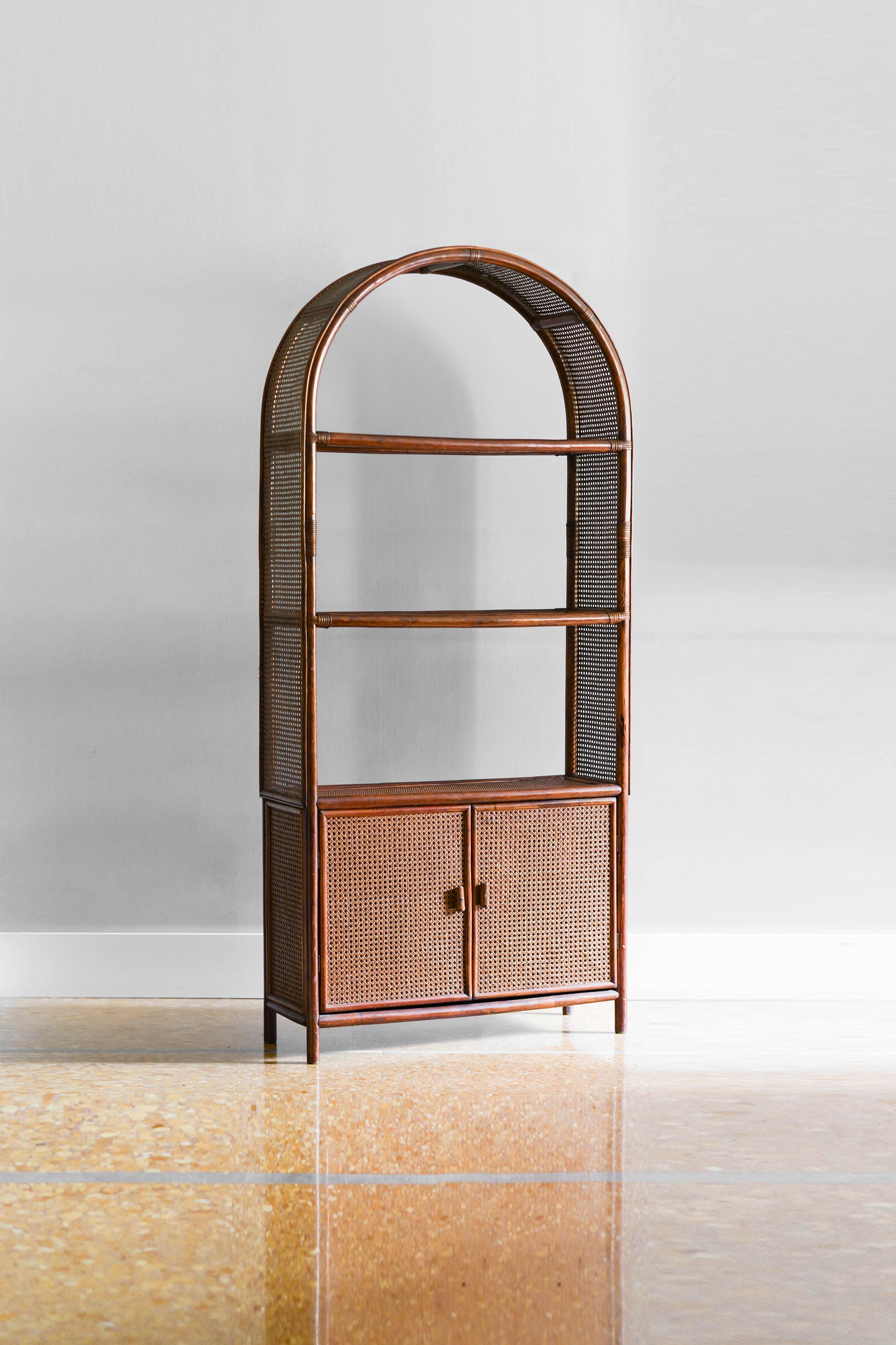 Bookcase in rush, wicker and Vienna straw. 
Product details
Storage unit with shelves and doors in dark finish.
Dimensions: 90 W x 200 H x 32 D
Production: Italy in the 80s.