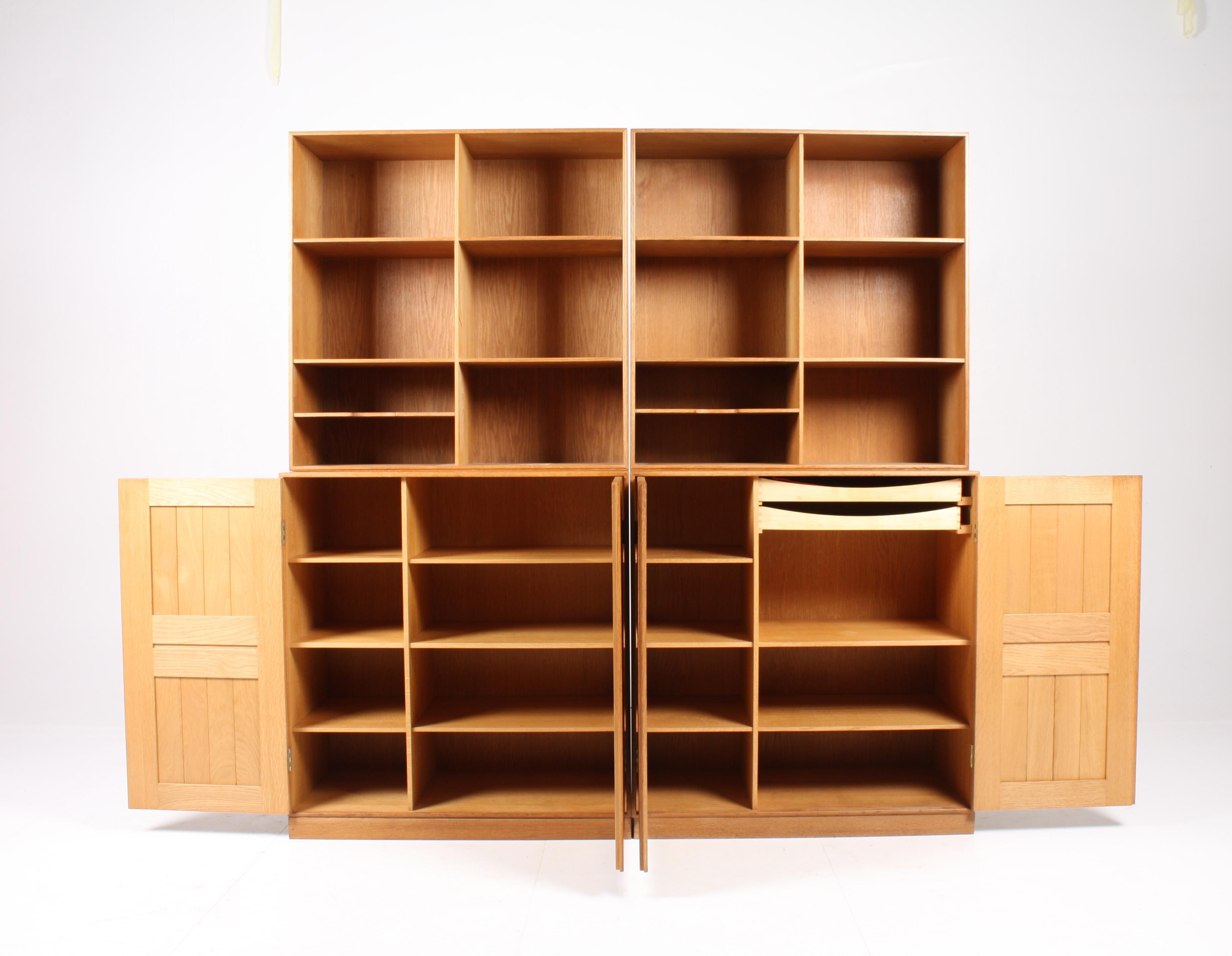 4 section bookcase in solid oak designed by MAA. Mogens Koch for Rud. Rasmussen Cabinetmakers. Two cabinets and two bookcases, can be used on the floor or wall-mounted. Nice patinated condition. Made in Denmark, circa 1960.