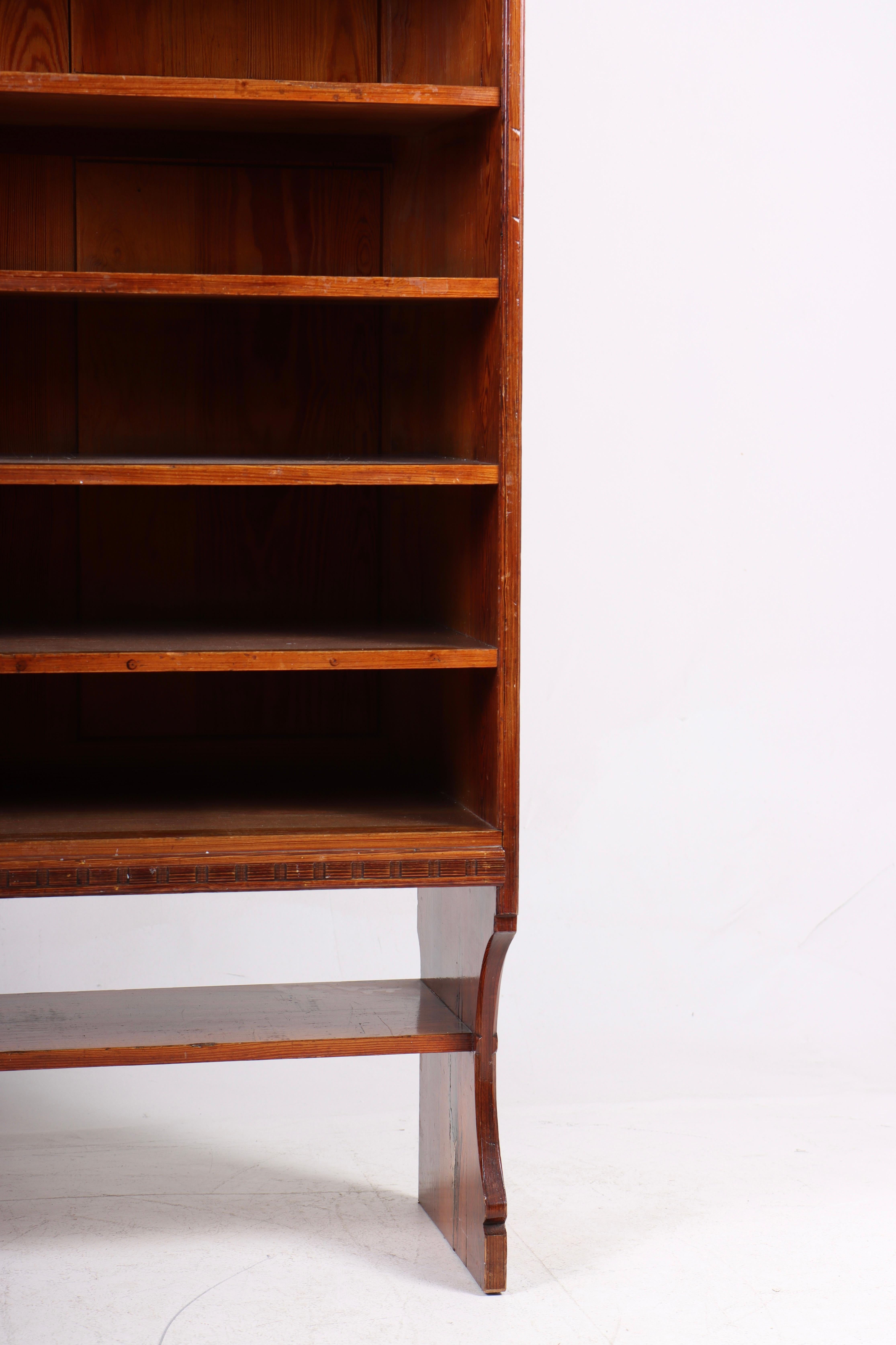 Bookcase in patinated solid pine. Designed by MAA. Martin Nyrop as interior for Copenhagen town hall in 1905. Made in Denmark by Cabinetmaker Rud Rasmussen cabinetmakers. Great original condition.