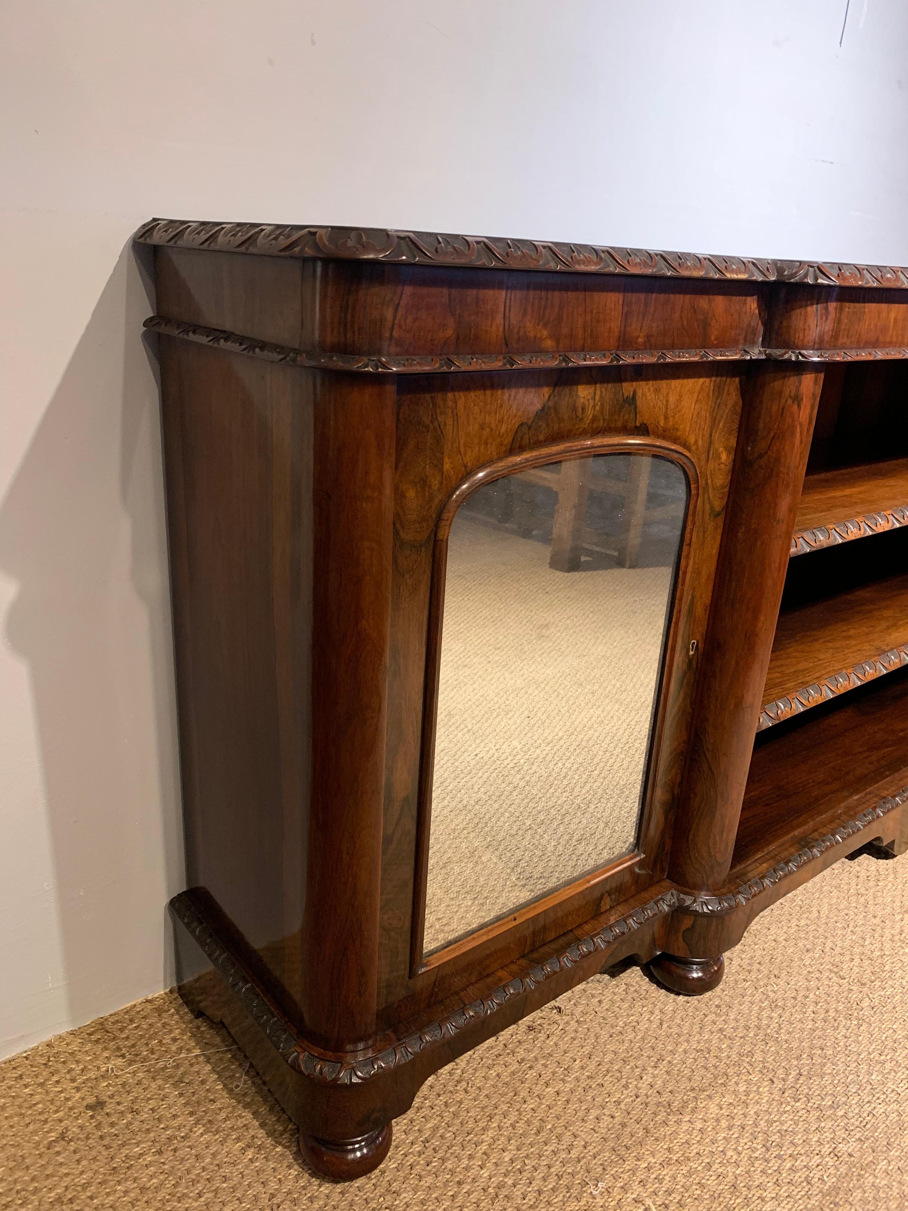Very good quality mid Victorian long and low bookcase 

English Dating to circa 1860s, having been through our workshops. Been cleaned / polished original mirrors to the cupboards, working locks and key 

The 2 central shelves are fully
