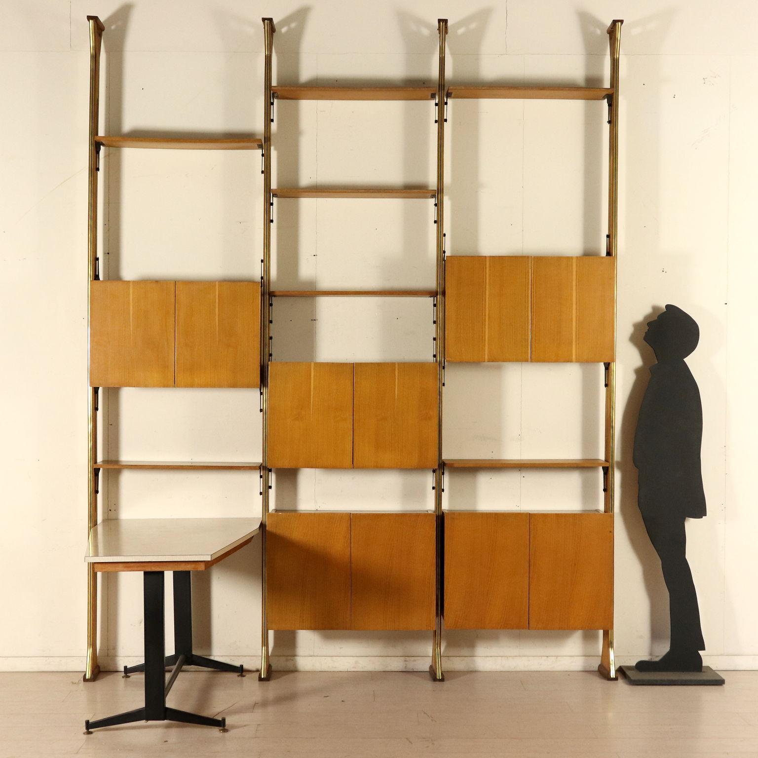 A bookcase with desk and adjustable elements. Oak and formica veneer, brass, metal. Manufactured in Italy, 1960s.