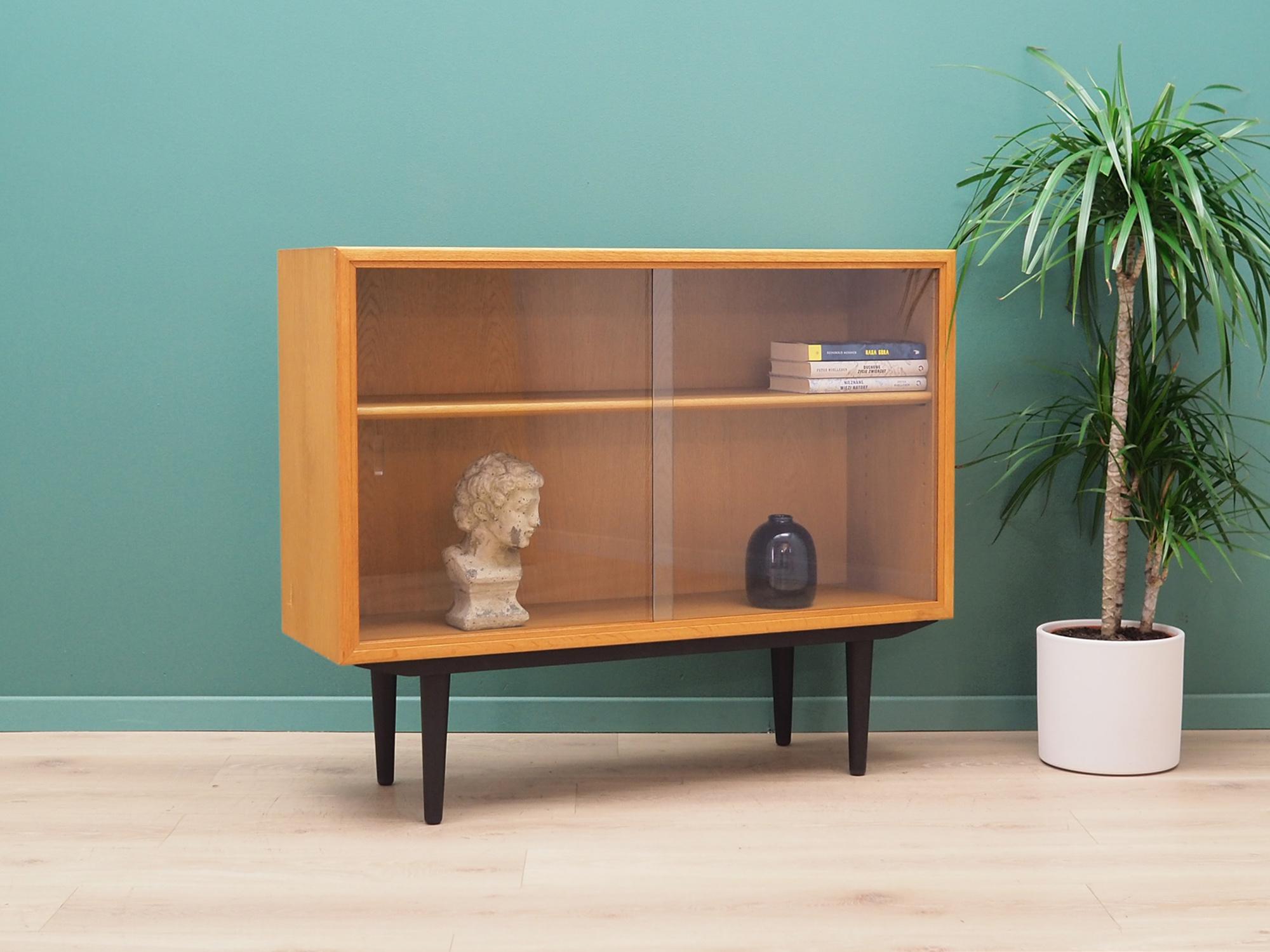 Bookcase was made in the 1960s and was produced by the well-known Danish factory Søborg. It was designed by leading Danish designer Borge Møgensen.

The structure is covered with oak veneer. The legs are made of solid wood stained black. Surface