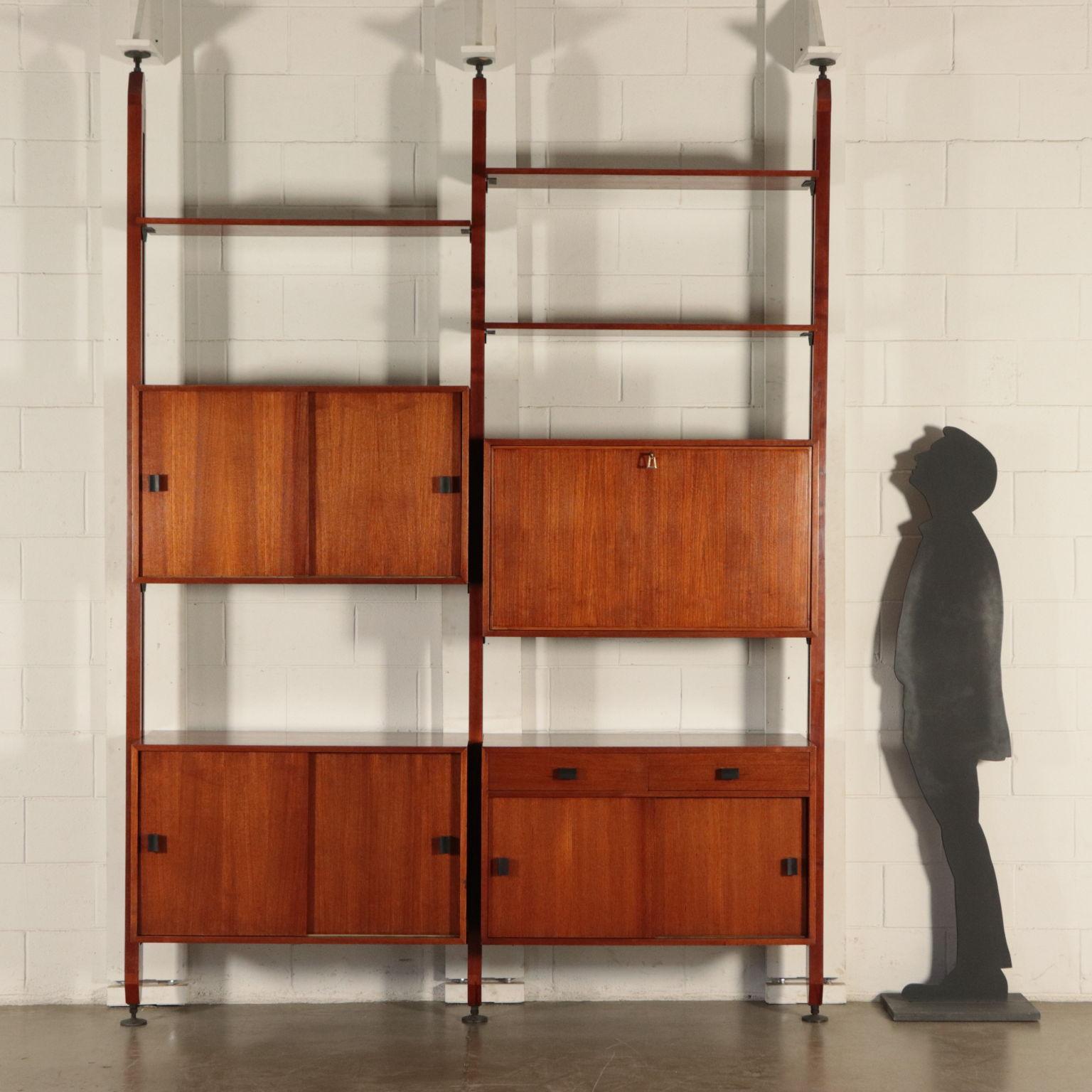 Ceiling bookcase, also usable as a partition side is refined also on the back. Container elements and swing doors, shutter, pooket flap, adjustable open shelfs; solid wood and teak veneered wood.