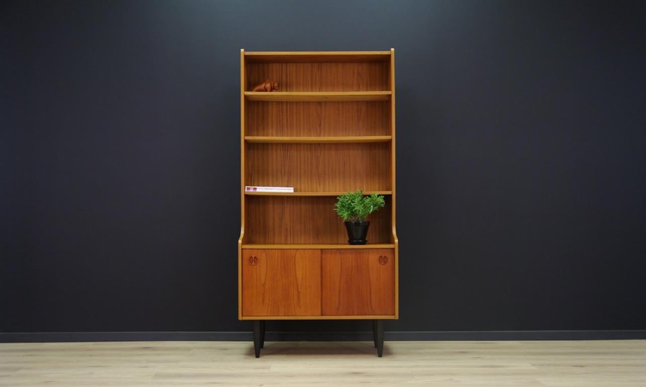 Fantastic library - cabinet from 1970s - minimalistic form - Scandinavian design. Form veneered with teak. Roomy interior with a shelf behind the sliding doors at the bottom. Shelves are adjustable. Preserved in good condition (small dings and