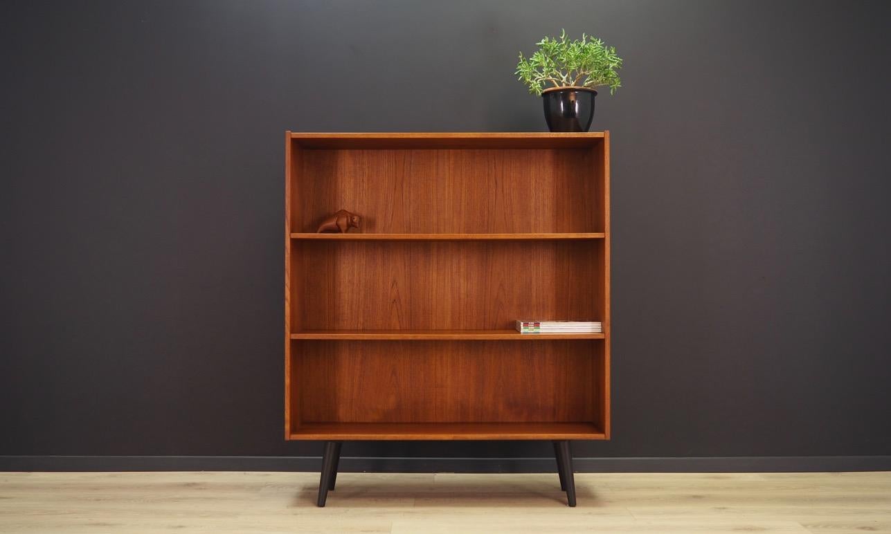 Classic bookcase / library from the 1960s-1970s. Scandinavian design, Minimalist form. Surface of the furniture finished with teak veneer. Bookcase has two shelves with no possibility of adjustment. Preserved in good condition (minor bruises and
