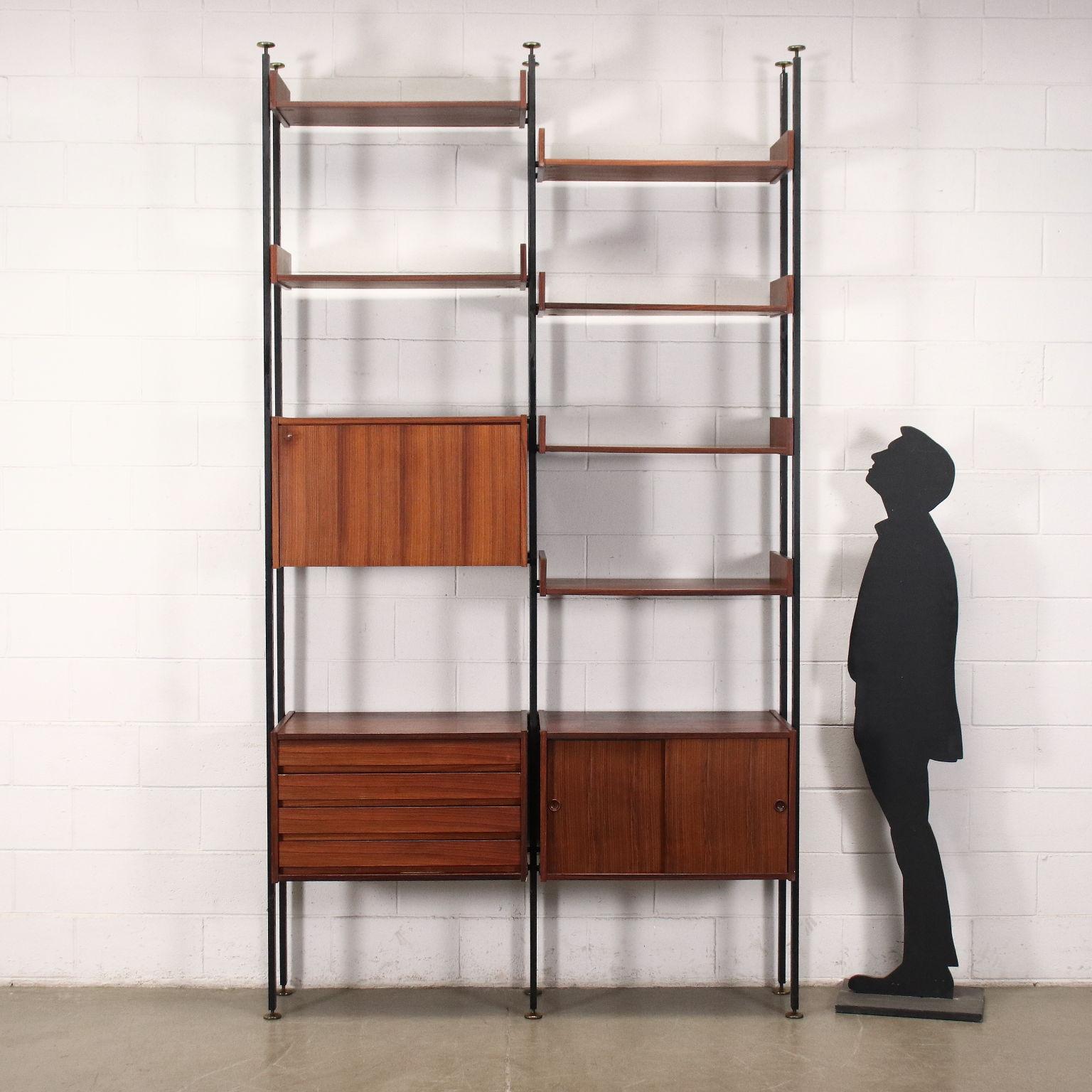 Freestanding bookcase from the 1950s-60s with storage compartments and adjustable shelves. In veneered wood, it has metal uprights.