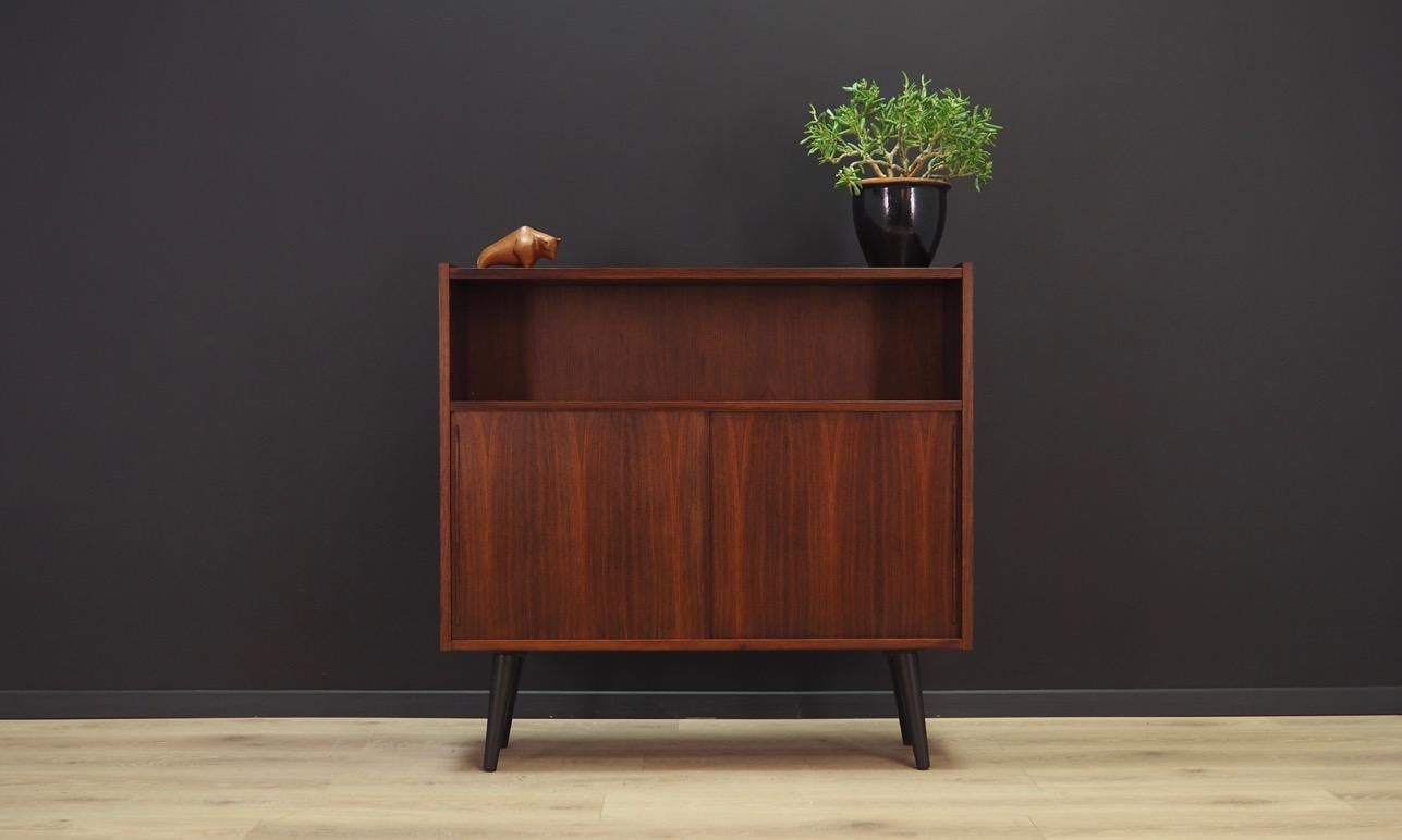 Exceptional bookcase from the 60 / 70's. Danish design - minimalist form. Surface of the furniture finished with rosewood veneer. Shelf behind a sliding doors. Maintained in good condition (minor bruises and scratches) - directly for