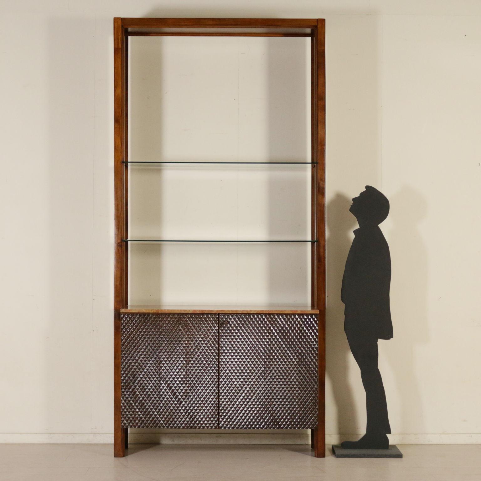 A bookcase, walnut veneer, decorative panels made of carved wood, marble and glass shelves. Manufactured in Italy, 1960s.