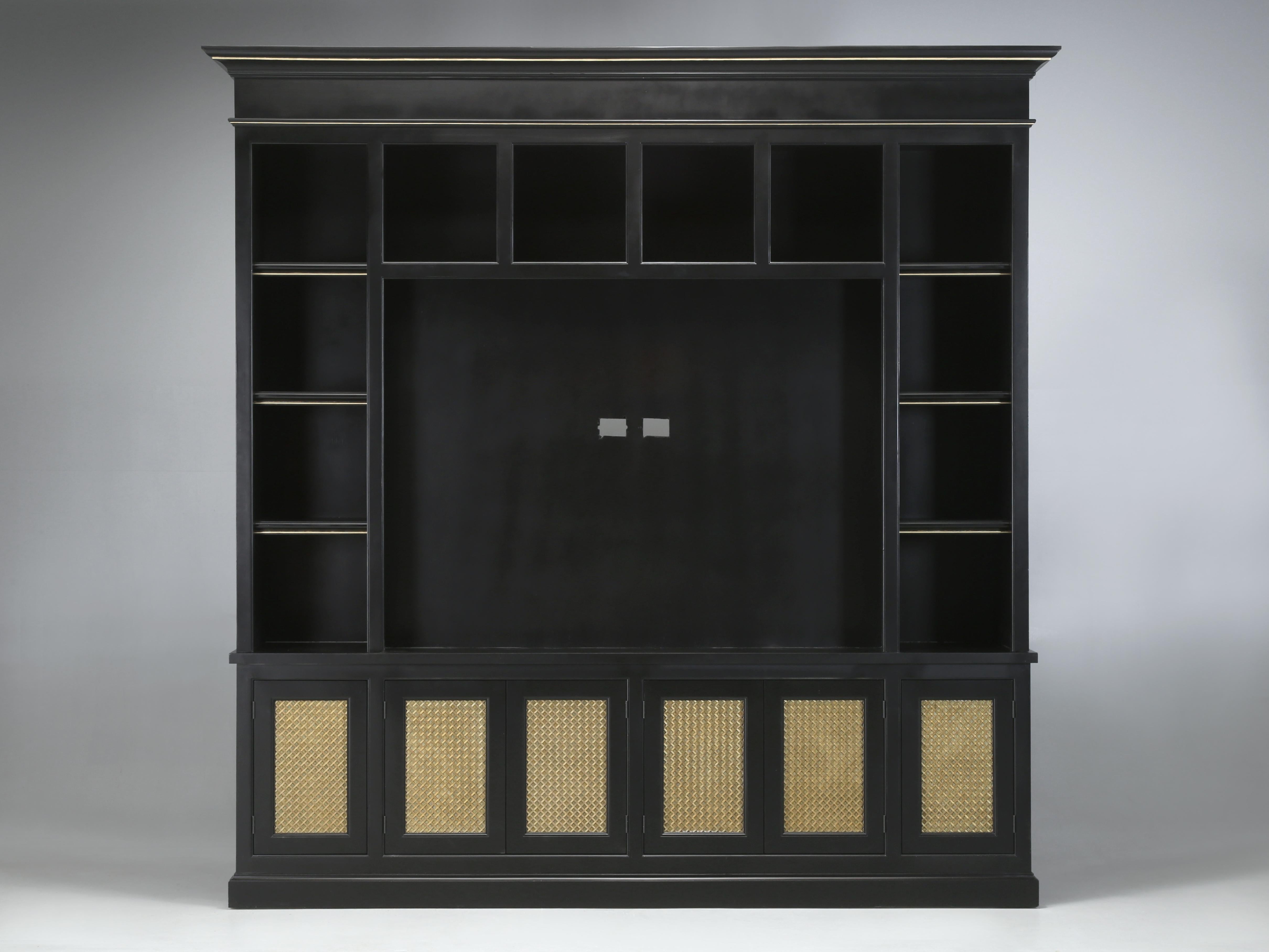 Bookcase with a Large TV Center Section in Black with Woven Brass Door Panels and painted Brass trim. Well constructed by a local cabinet company and used for only a few months. Certainly not flawless, but extremely heavy and is built from wood and