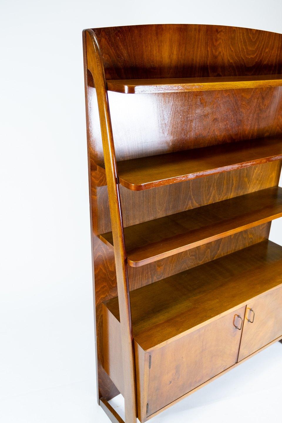 Bookcase with cabinet beneath in walnut of Danish design from the 1950s. The case is in great vintage condition.
 