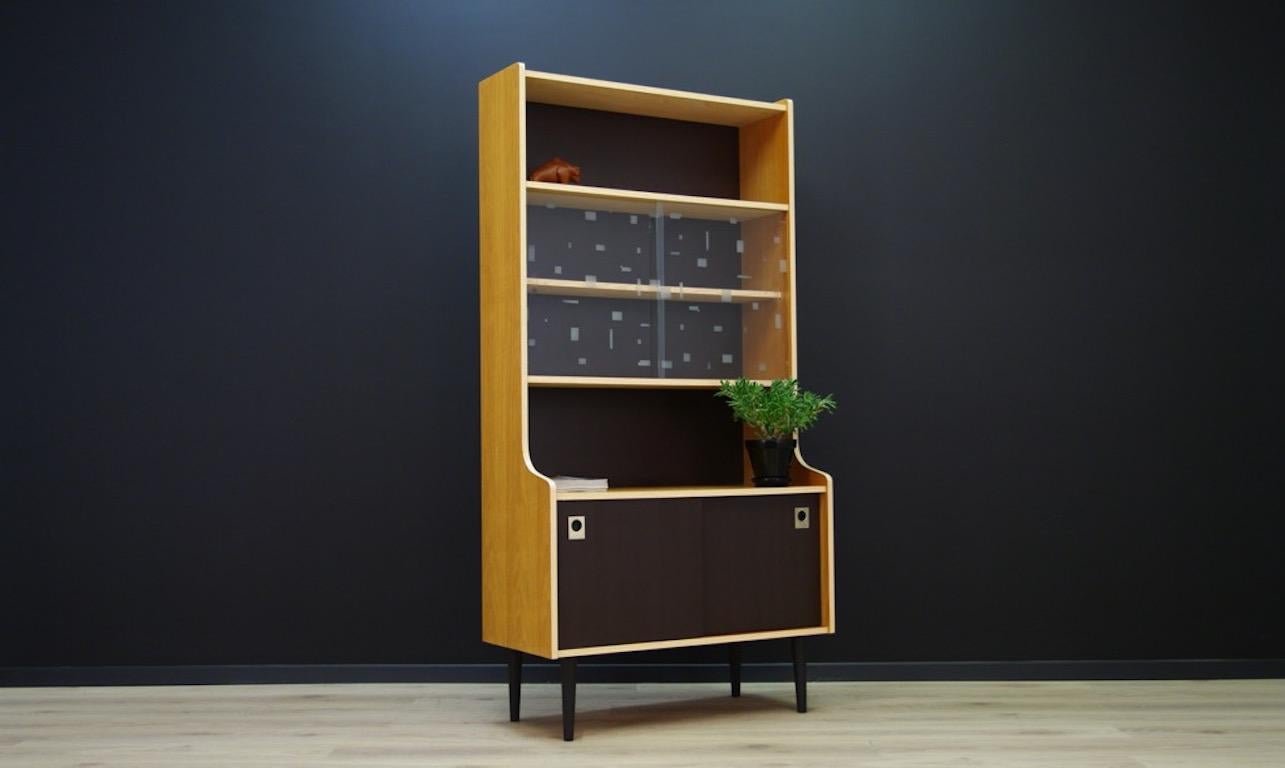 Unconventional cabinet or bookcase from the 1960s-1970s, Scandinavian Danish. The chest of drawers finished with ash veneer, fronts of the door and the rear wall of the furniture colored in brown paint, perfectly contrast with the bright ash,
