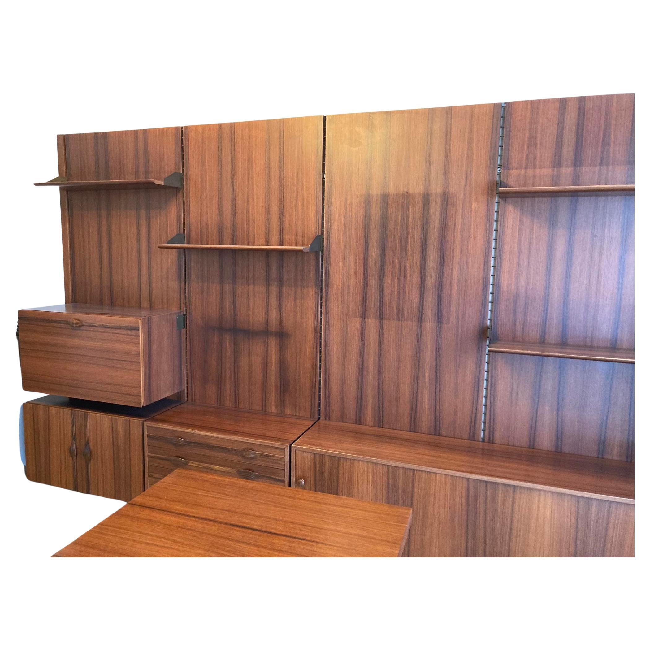 Bookcase Mid-Century Modern Iatalian work. The suspense bookcase made up of 4 vertical pannels to be attached to the woll to which the shelves and walls units hang, which can positioned as desired. The Bookcase can be diveded to form two twin