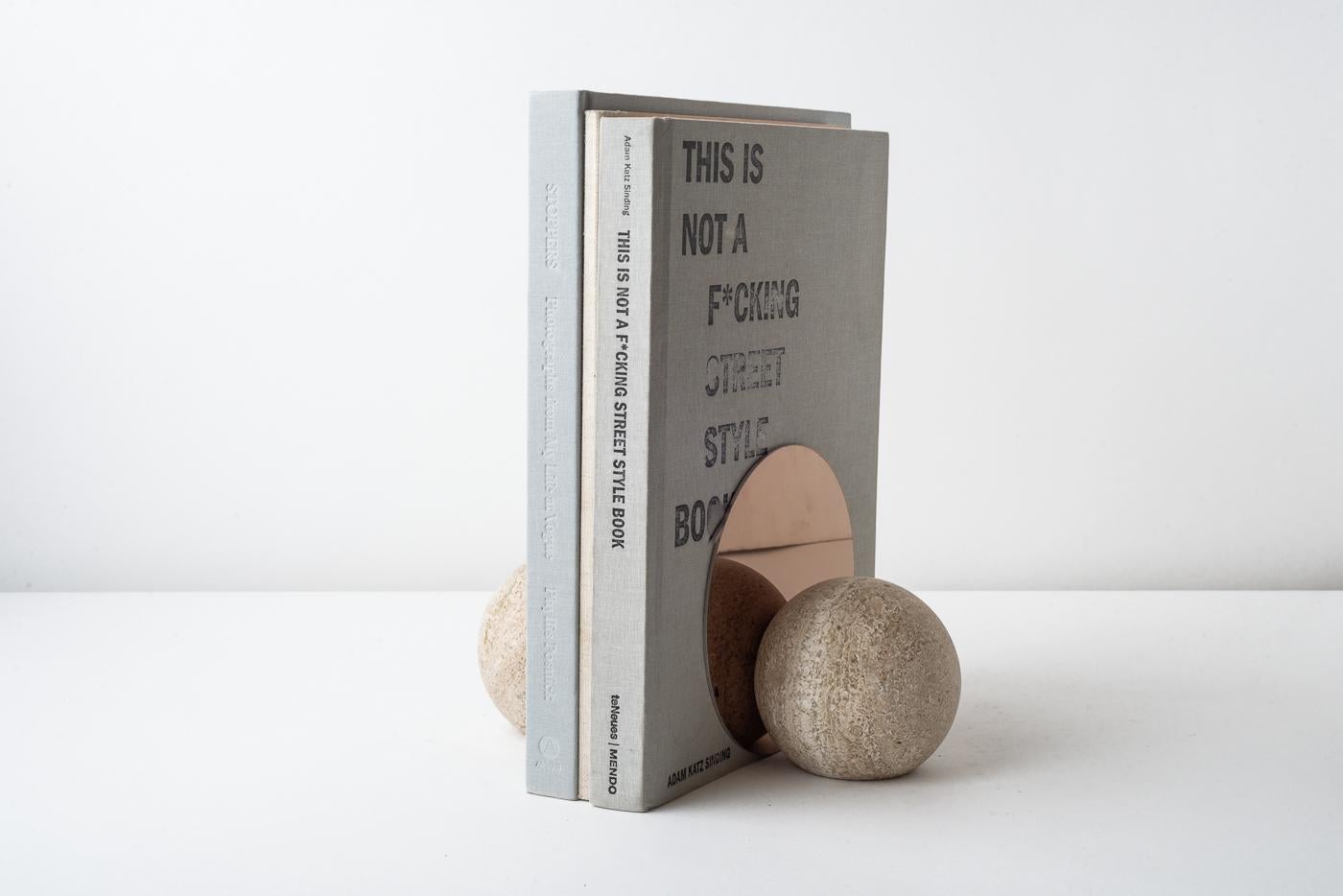 Introducing a truly luxurious addition to your personal library - a stunning pair of hand-carved marble bookends from the artisanal experts at bruci. These spherical bookends are exquisitely detailed with a vertical stainless steel plate boasting a