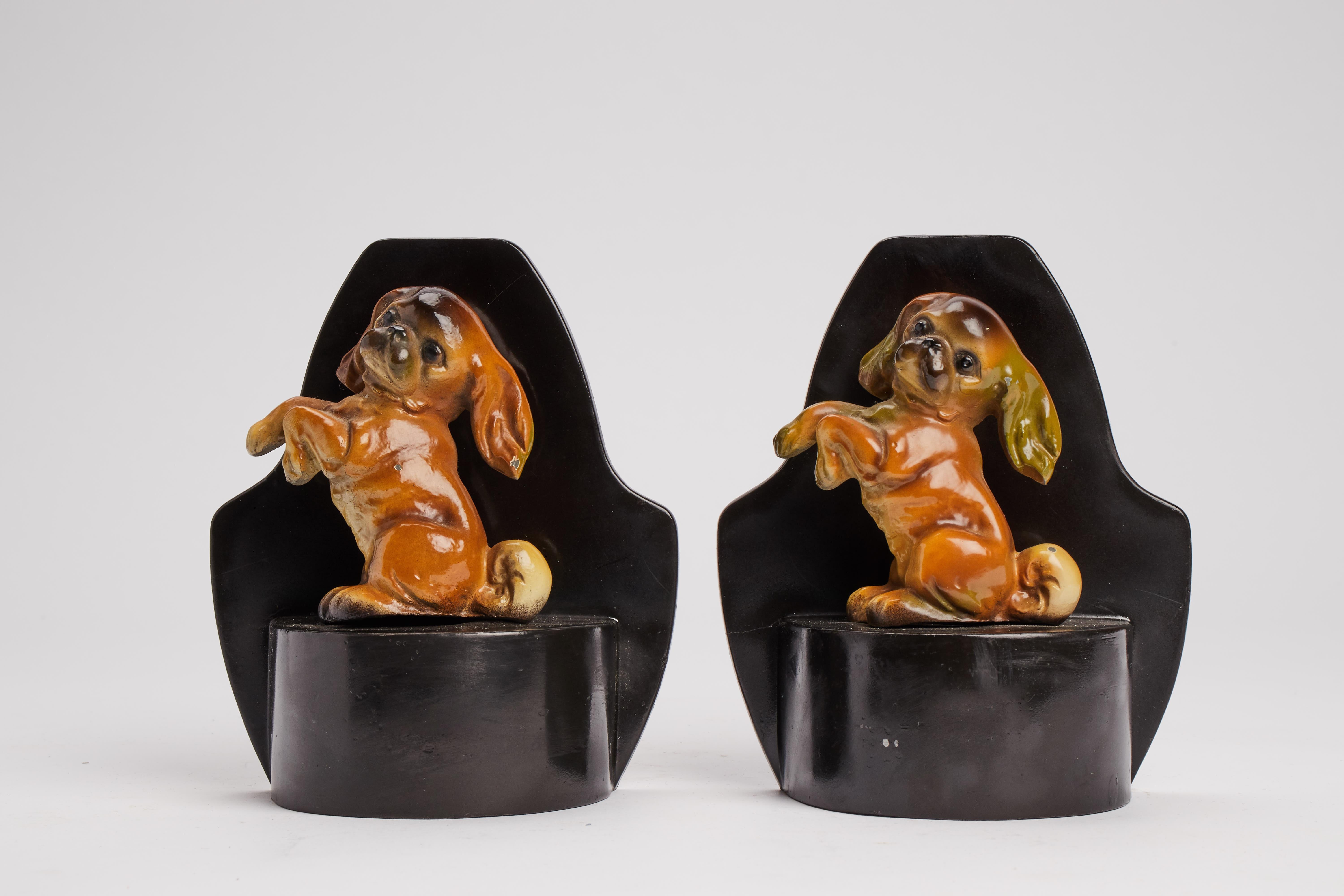 Pair of enameled metal bookends dipicting a Pekingese dog breed. France circa 1915.