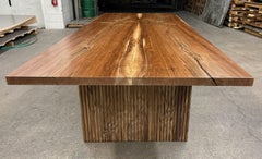 Bookmatched walnut top dining table with fluted walnut legs