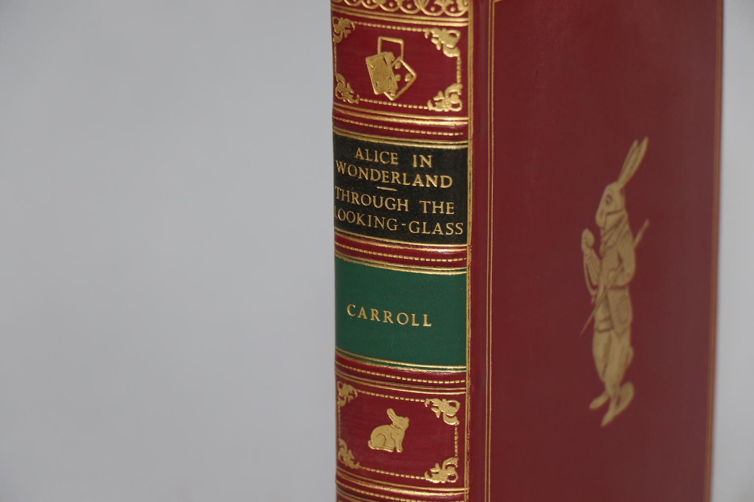 Leatherbound. One volume. Bound in full red calf by Bayntun Binders with all edges gilt, raised bands on spine, and gilt tooling on covers and spine. Illustrated by John Tenniel. Very good. Published in London by Macmillan at St. Martin's Press in