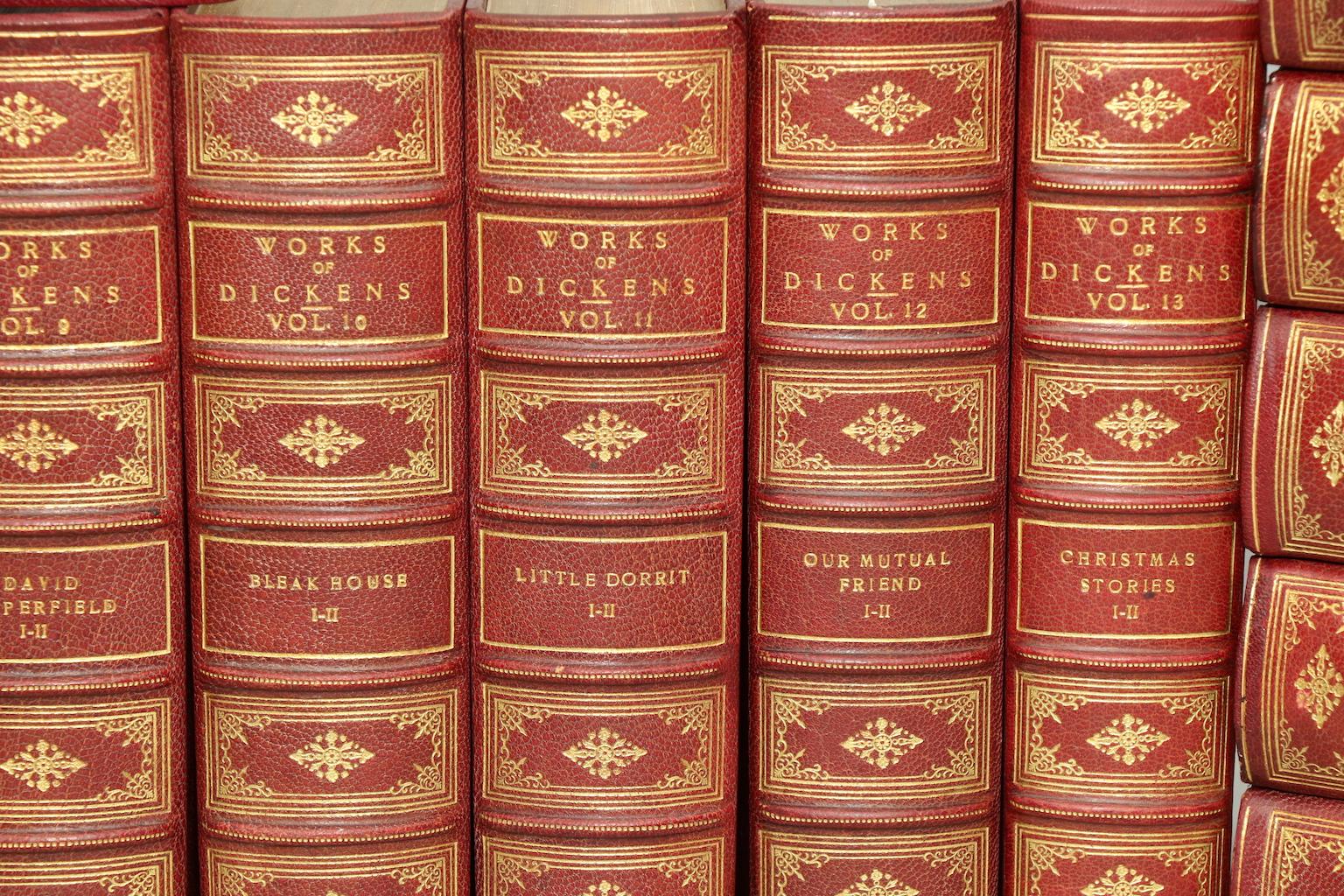 George Cruikshank & Hablot K. Browne. National Library Edition. Leatherbound. 20 volumes. Bound in three quarter red morocco, top edges gilt, raised bands, and ornate gilt on spines. Profusely illustrated throughout by George Cruikshank and Hablot