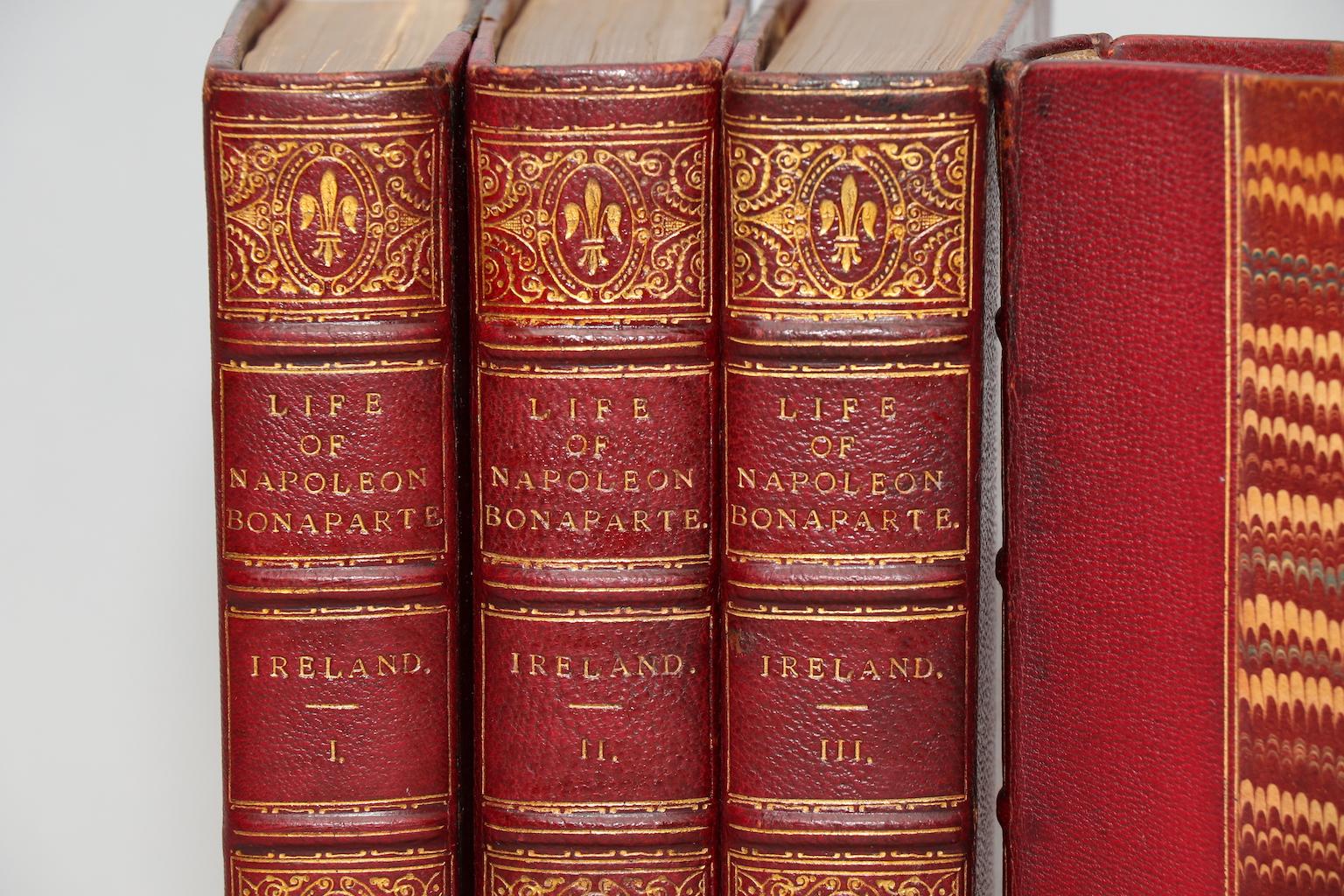 Ireland's Classic biography of Napoleon, with the fine hand-colored plates by Cruikshank.

First Edition. Leatherbound. Four volumes. Octavo. Bound in half red crushed Levant morocco and marbled boards. Bookplates of J. Barton Townsend and William