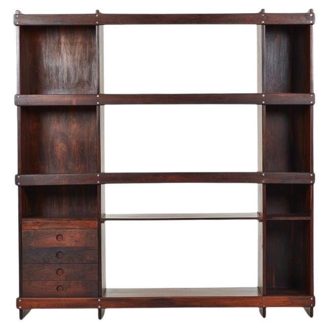 Bookshelf designed by Sergio Rodrigues and crafted by OCA in Brazil during the 1960s. This timeless piece embodies the essence of mid-century modern design with its rich Brazilian Rosewood and elegant shelves. The model 