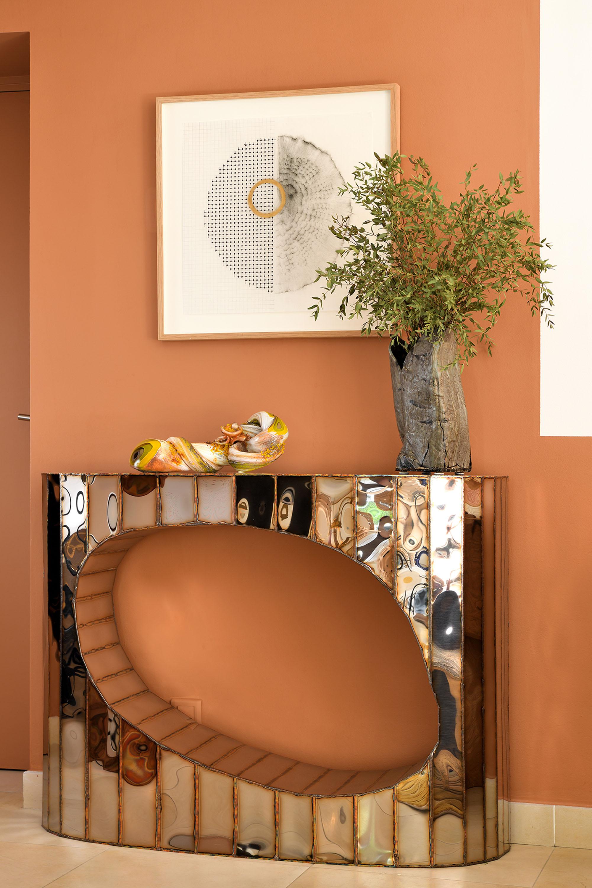 Boole Console in Welded Mirror-Polished Stainless Steel by Julian Mayor
Limited Edition of 8 + 4AP.
Dimensions: D 30 x W 120 x H 90 cm. 
Materials: Mirror-polished stainless steel.

Julian Mayor is a British artist and designer renowned for his