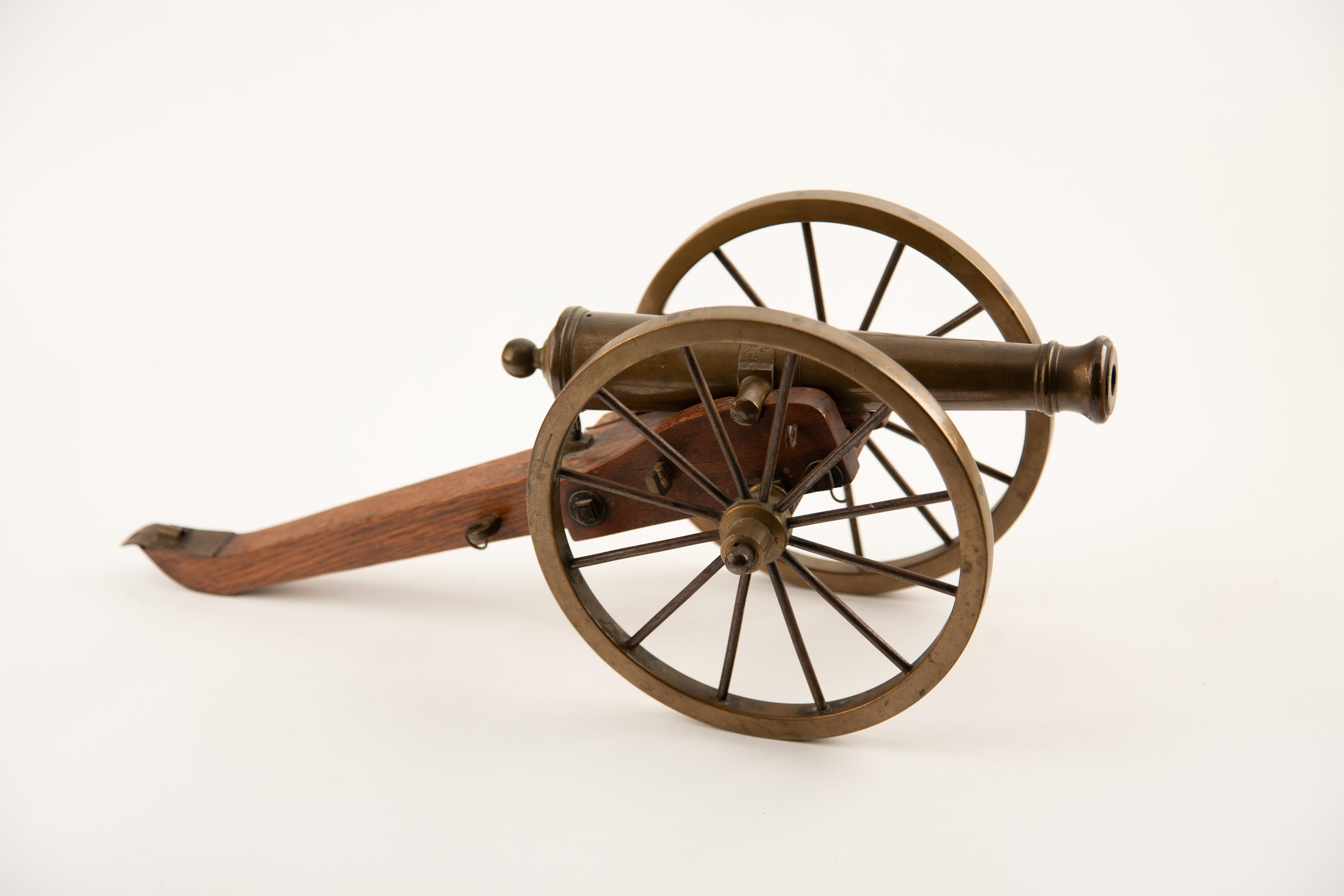 Late 19th Century Brass and Wood Model Cannon, dated 25 August 1888 and signed “G. Meyer.” This finely crafted miniature artillery piece features a solid brass barrel mounted on a detailed wooden carriage with spoked brass wheels and iron fittings,