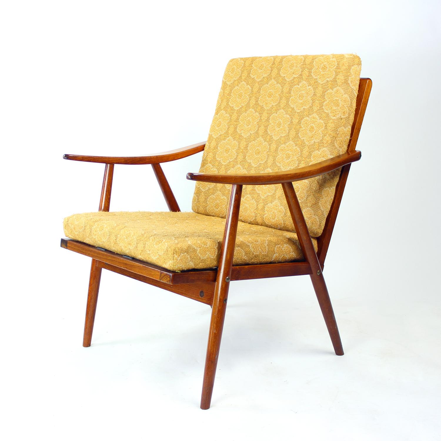 Beautiful vintage armchair produced by TON company in 1960s. The armchair is known as the Boomerang chair, named after the shape of the armrests which are made of bent woods and slightly remind of the the boomerang. The armchair is light and stable,