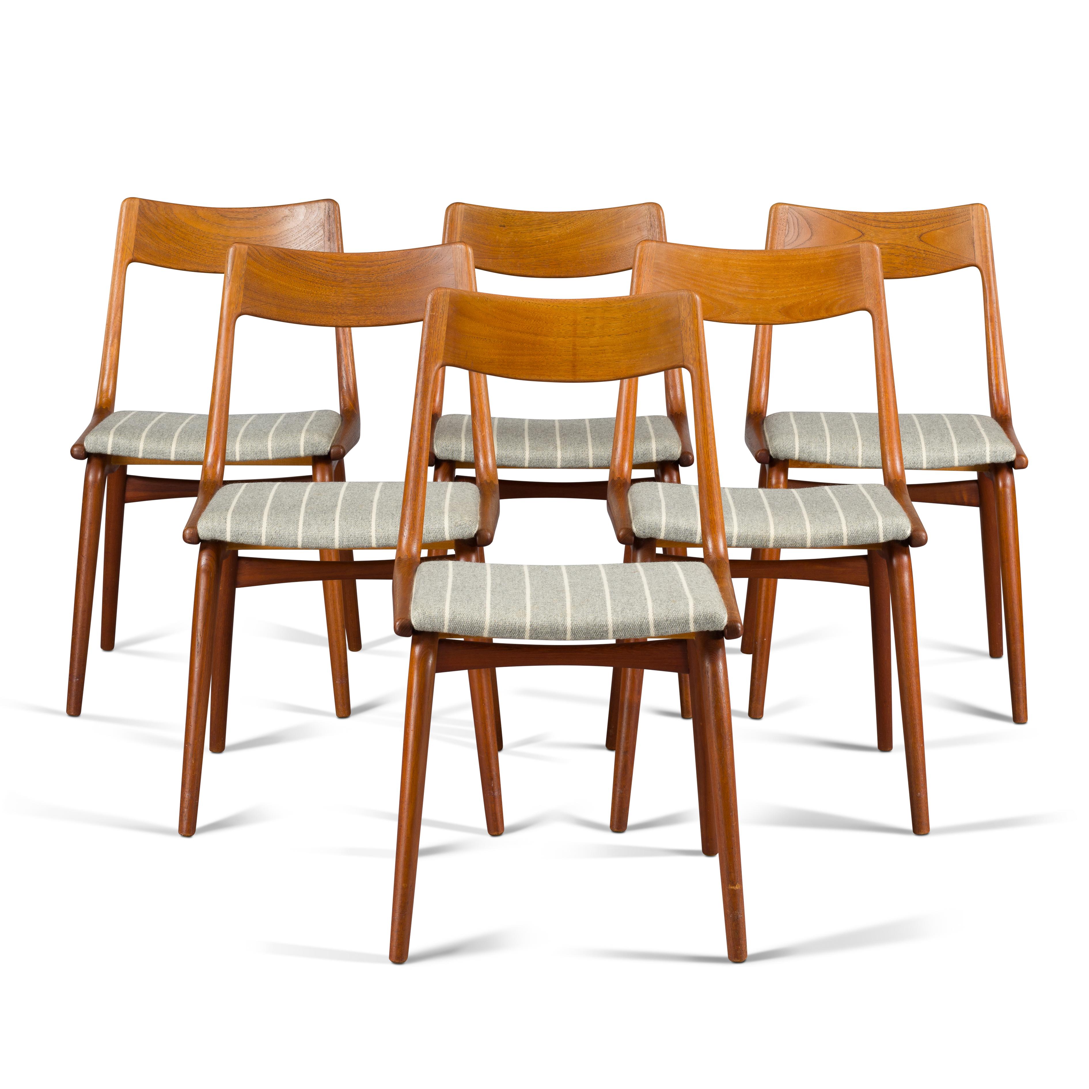 This dining chair is designed by Erik Christiansen and made from solid teak wood. The irresistible appeal of the chair is determined by the Boomerang shape of the back. The vintage wool upholstery is probably original and in good condition. But if