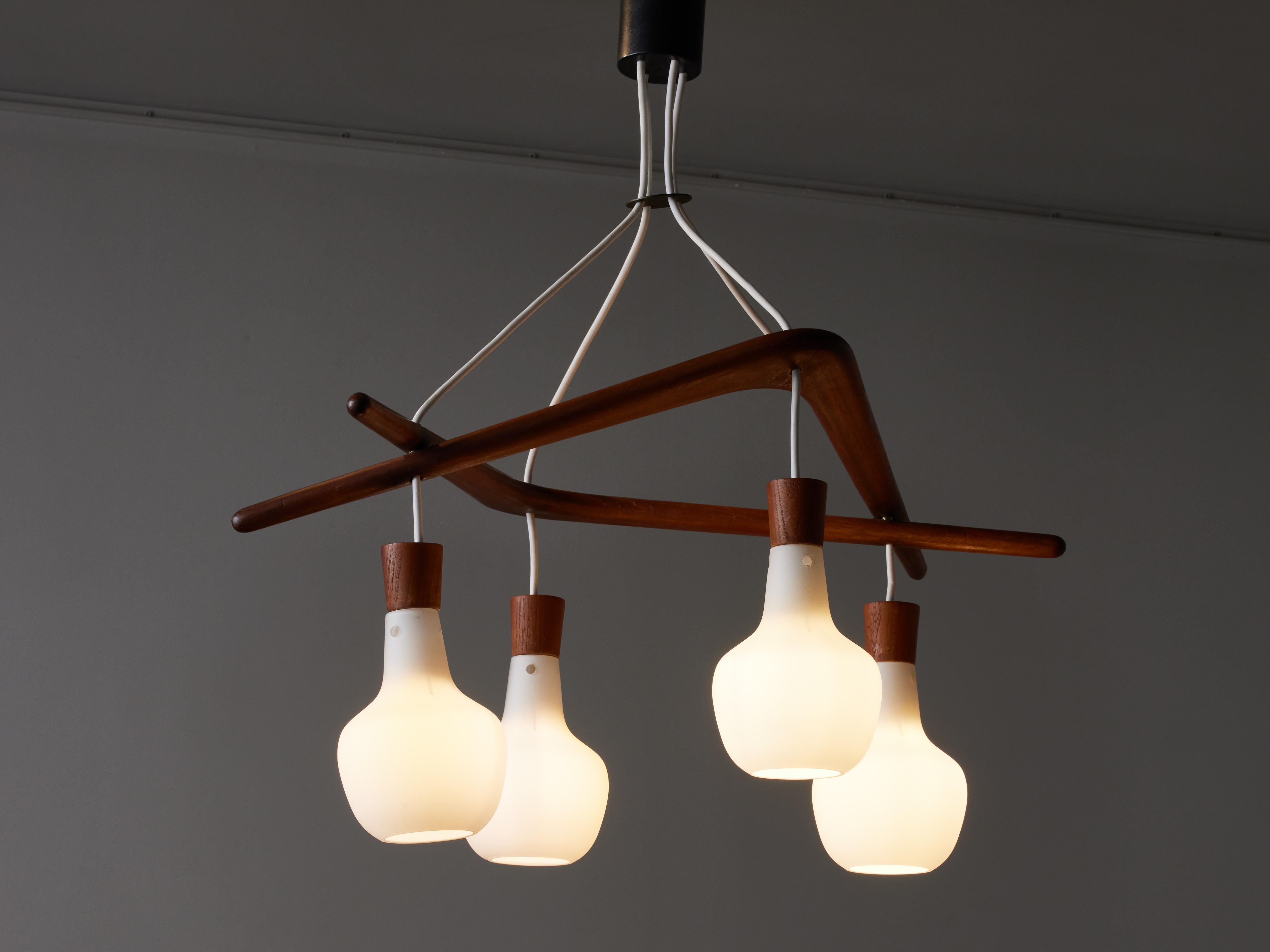 Boomerang chandelier by Rispal.

Chandelier made of two stained wood boomerang spreading four wires from where hang opaline glass shades.

The lighting manufacturer RISPAL was a French lighting brand based in Paris and active from the mid 1920’s to