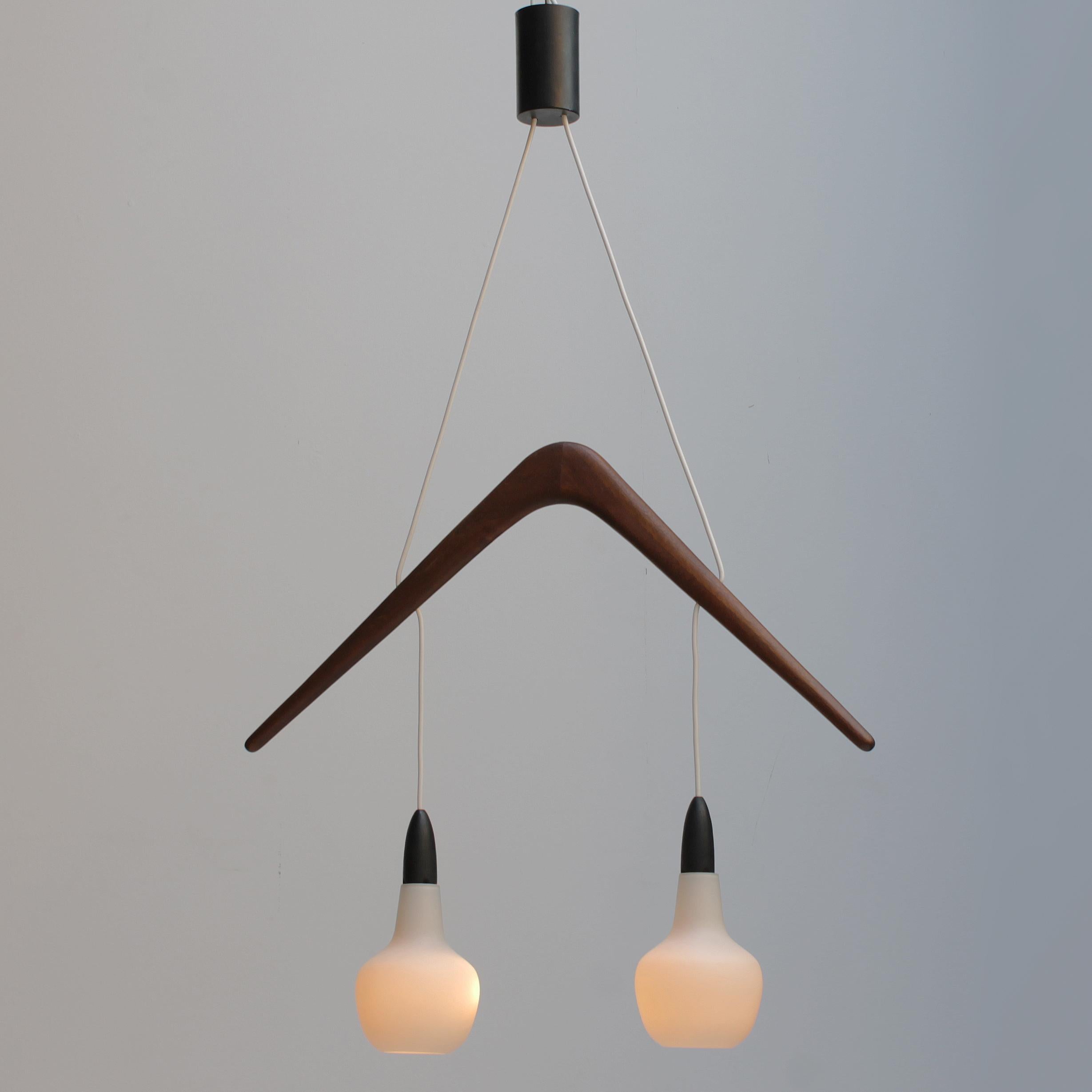Rare chandelier 'Boomerang by Rispal France, circa 1955.
Pair of Opaline glass pendants with the 'boomerang' in France walnut.
Original bayonet bulbs (BA15d, IEC 7004-11 A, DIN 49720) max 60 watt. The wire and the sockets are in a good condition,
