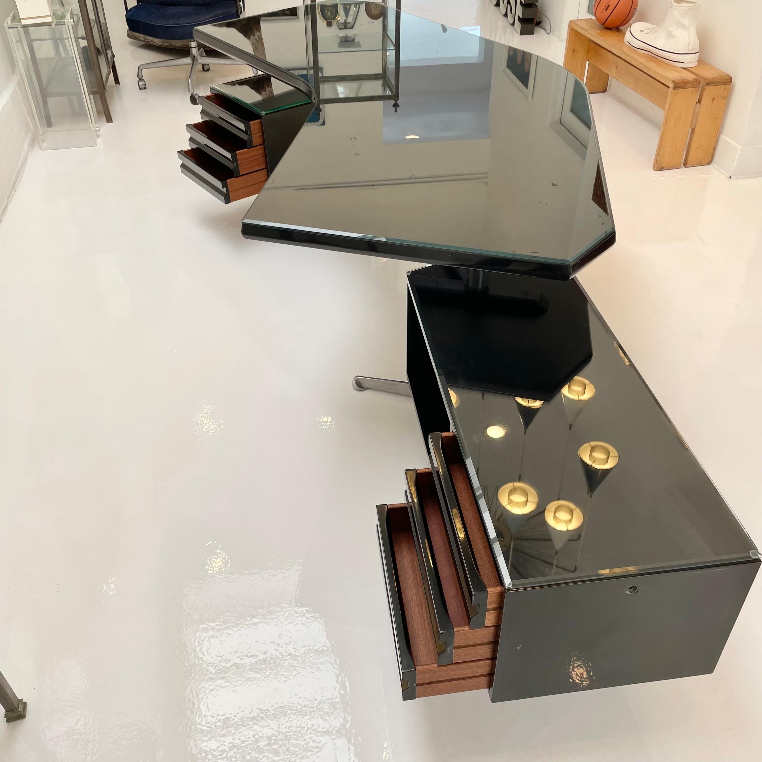 Architectural black boomerang executive desk by Osvaldo Borsani for Tecno Milano. Brought back to life in original black finish. Floating pedestal on left side and longer return on the right, both rotate 360 degrees. Three pull out drawers and