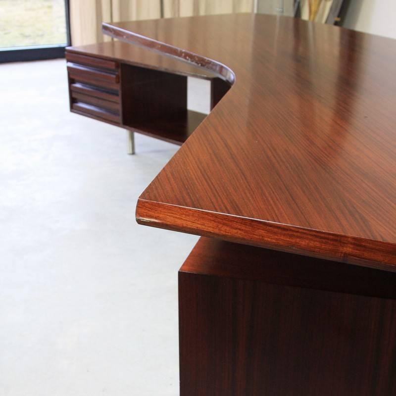 'Boomerang' desk, designed by Osvaldo Borsani, Italy, Tecno, 1956.

The 996 executive desk, using polished stainless steel supports with a rosewood top and drawers. The drawer units rotate around the desk supports and can be interchanged. Keys