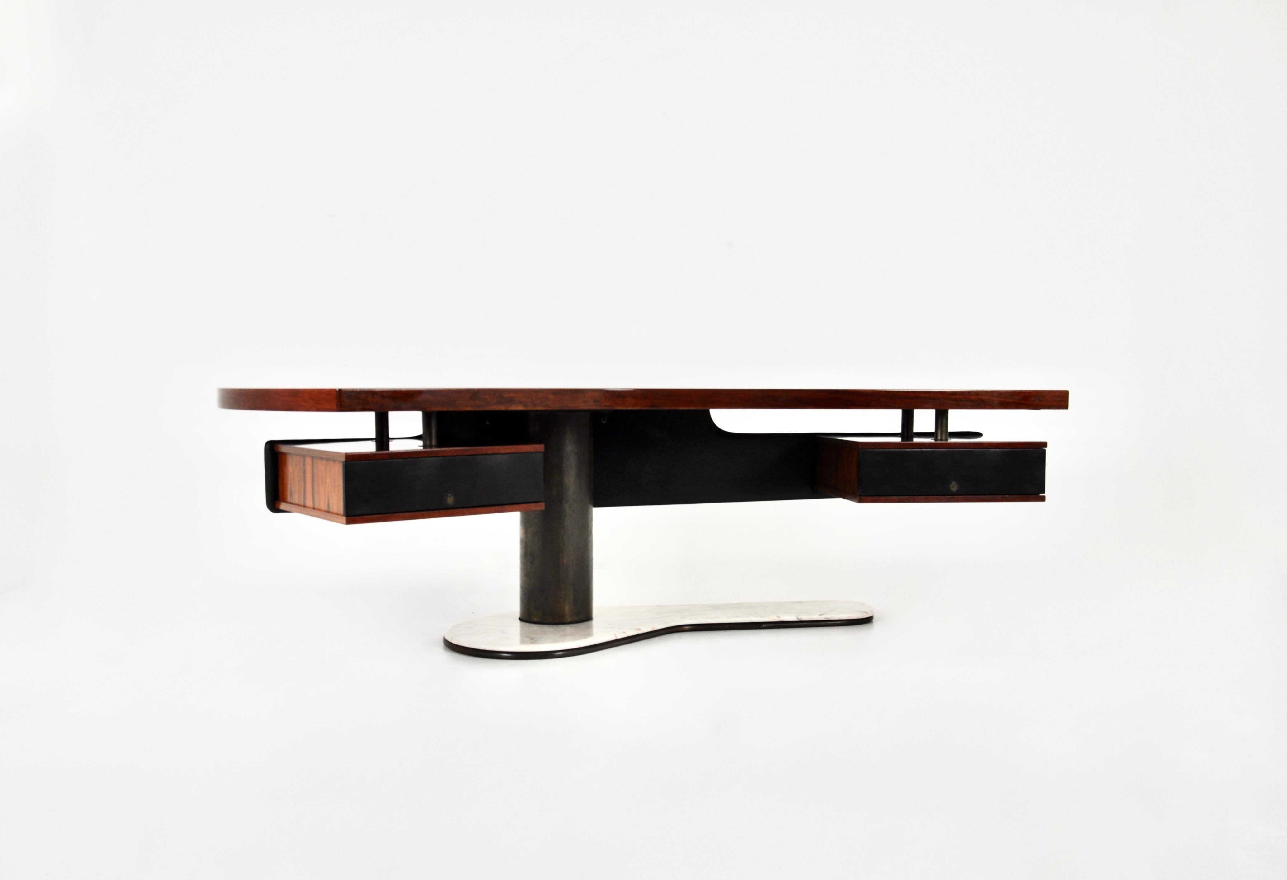 Beautiful boomerang desk with floating leather back panel and wood and leather drawers by Renzo Schirolli. The leg of the desk is in marble. No Keys. Wear due to time and age of the desk
For shipping, request us for receive the best price.