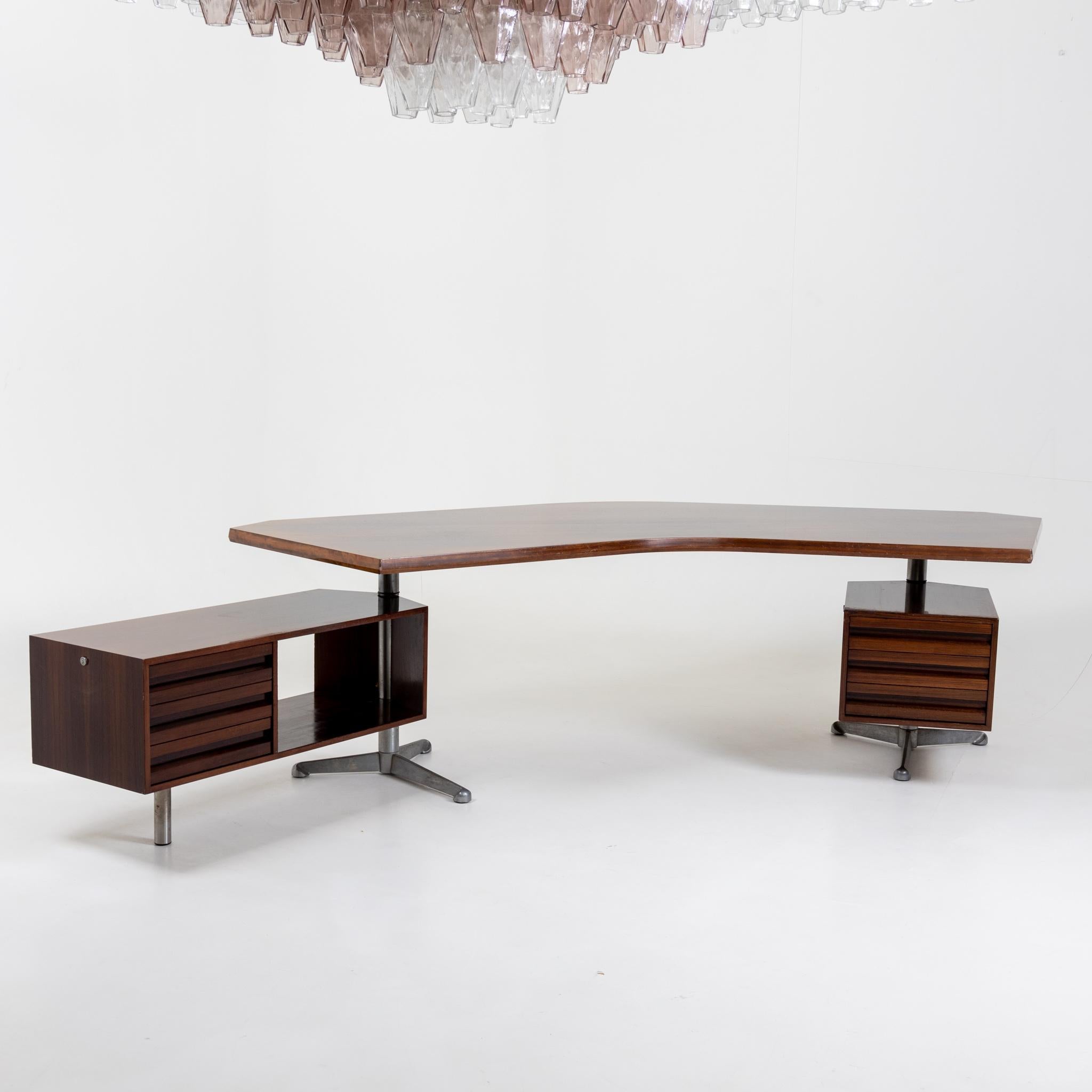 Large executive desk with curved table top and two drawer elements, the left element can be adjusted in angle. Tecno Milano label on the frame.