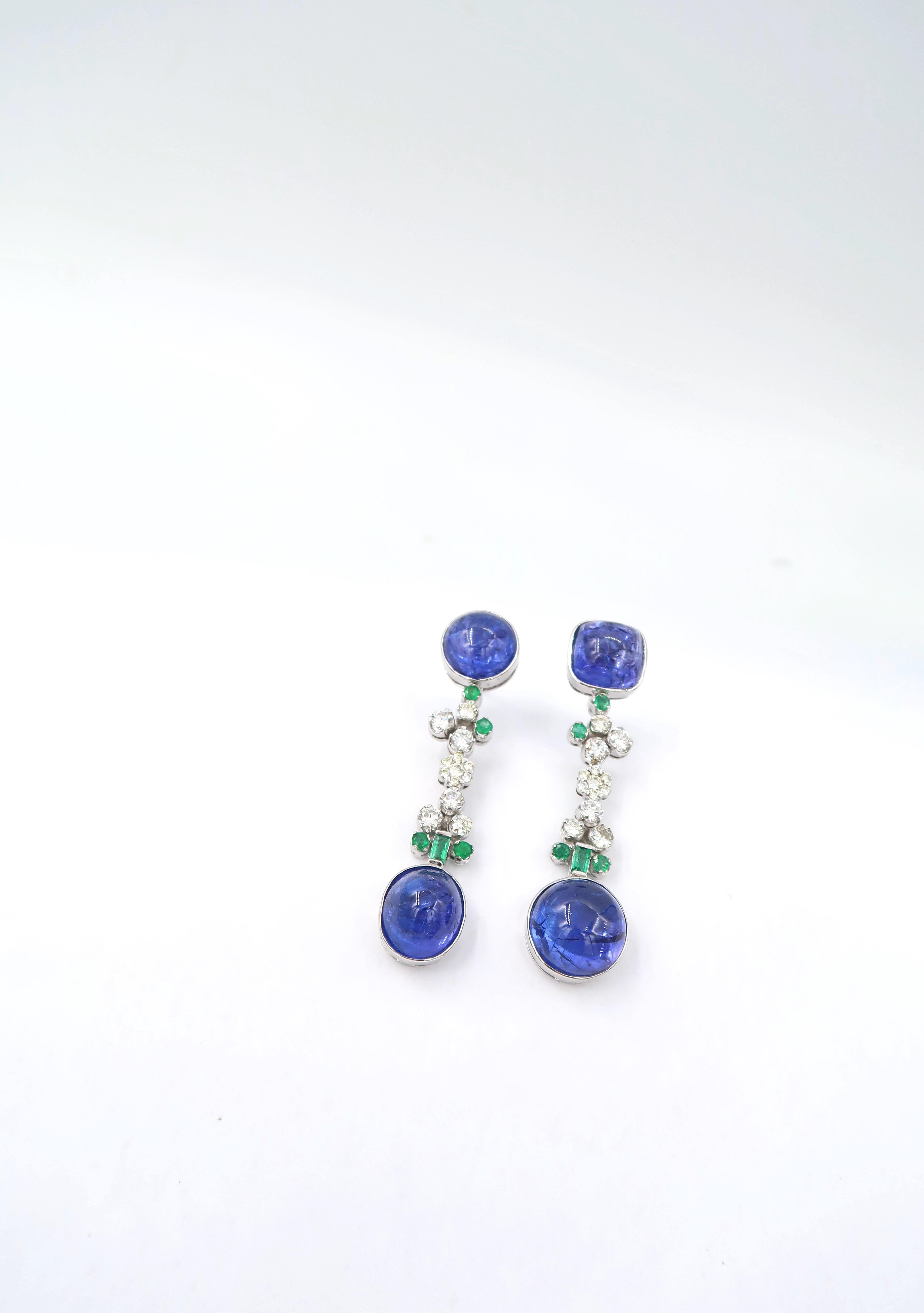 BOON Cabochon Tanzanite Drop Earrings in 18K White Gold with Emerald and Diamonds

Gold: 18K White Gold 17.28g.
Diamond: 1.38ct.
Tanzanite: Cabochon 34.70ct.
Emerald: 0.74ct.