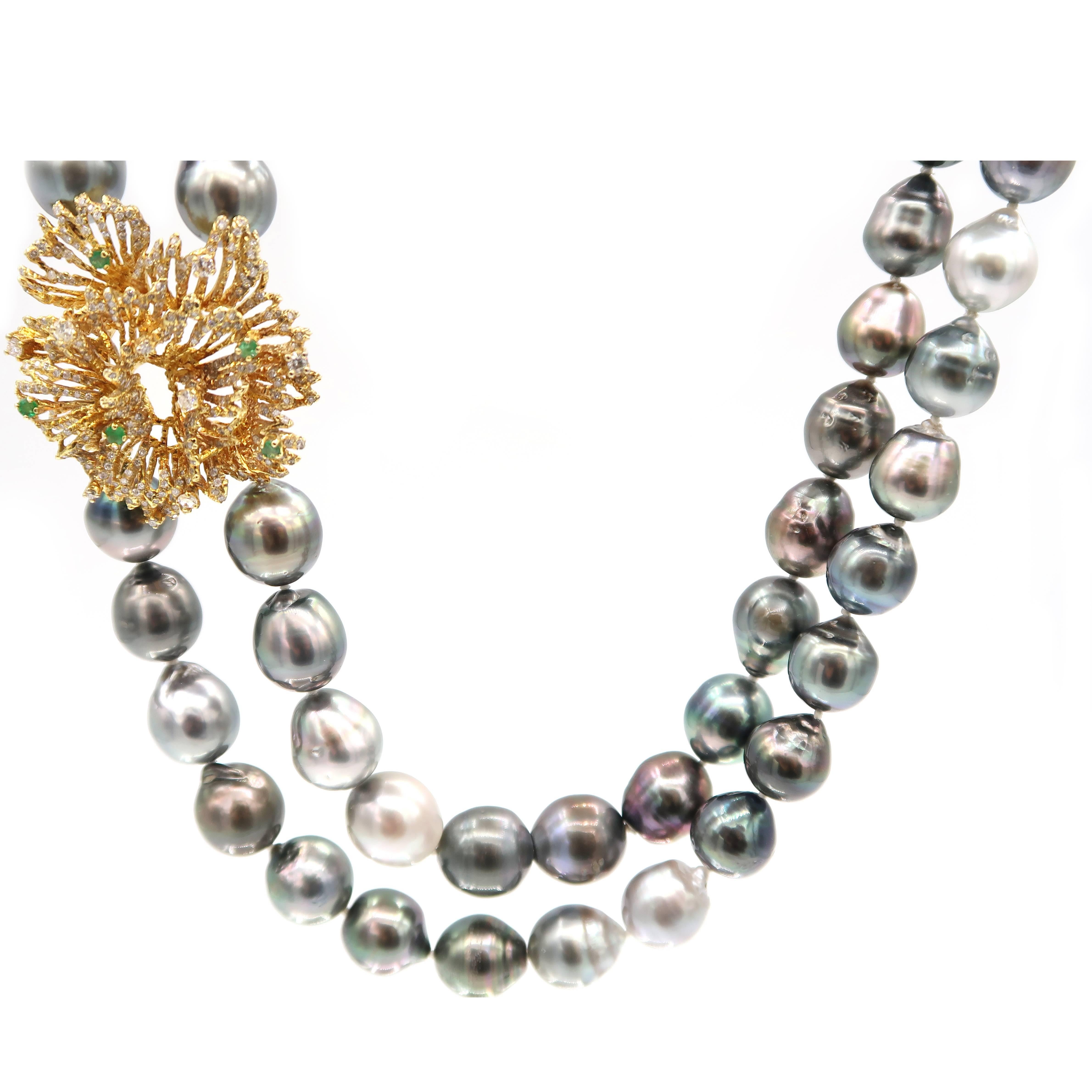 Shimmering diamond pendant with a spray of emerald complementing double-strand multicoloured natural Baroque Tahitian pearls. 

Gold: 18K Gold, 23.86 g
Diamond: 1.40 ct
Emerald: 0.40 ct

Inner Length: 21.25 inches
Outer Length: 23.25 inches