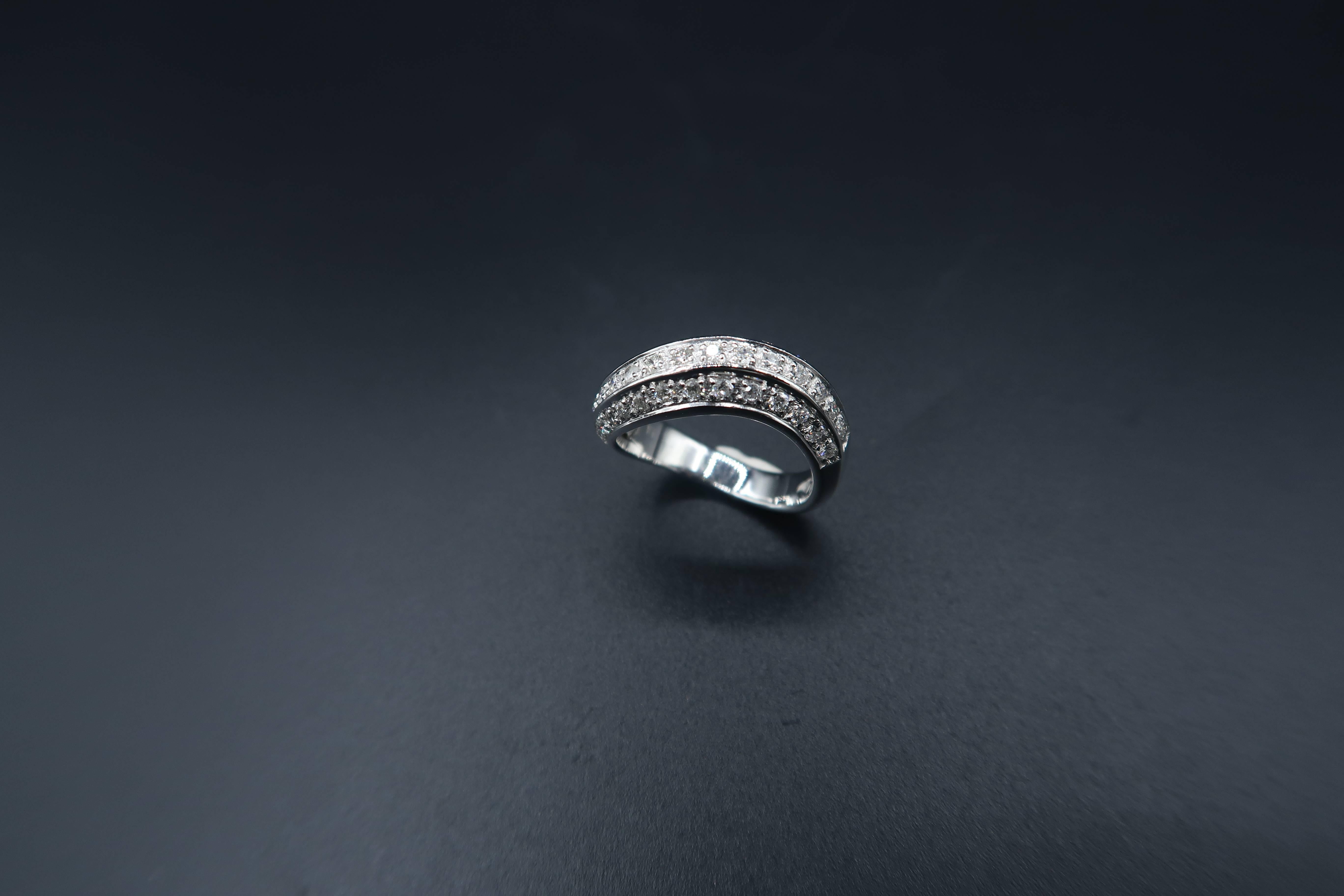 This 18K wavy white gold band ring is surrounded by round white diamonds, and finished with white gold edge.

Ring size: 50, UK J 1/2

Gold : 18K White Gold 5.409 g
Diamond : 0.70 ct