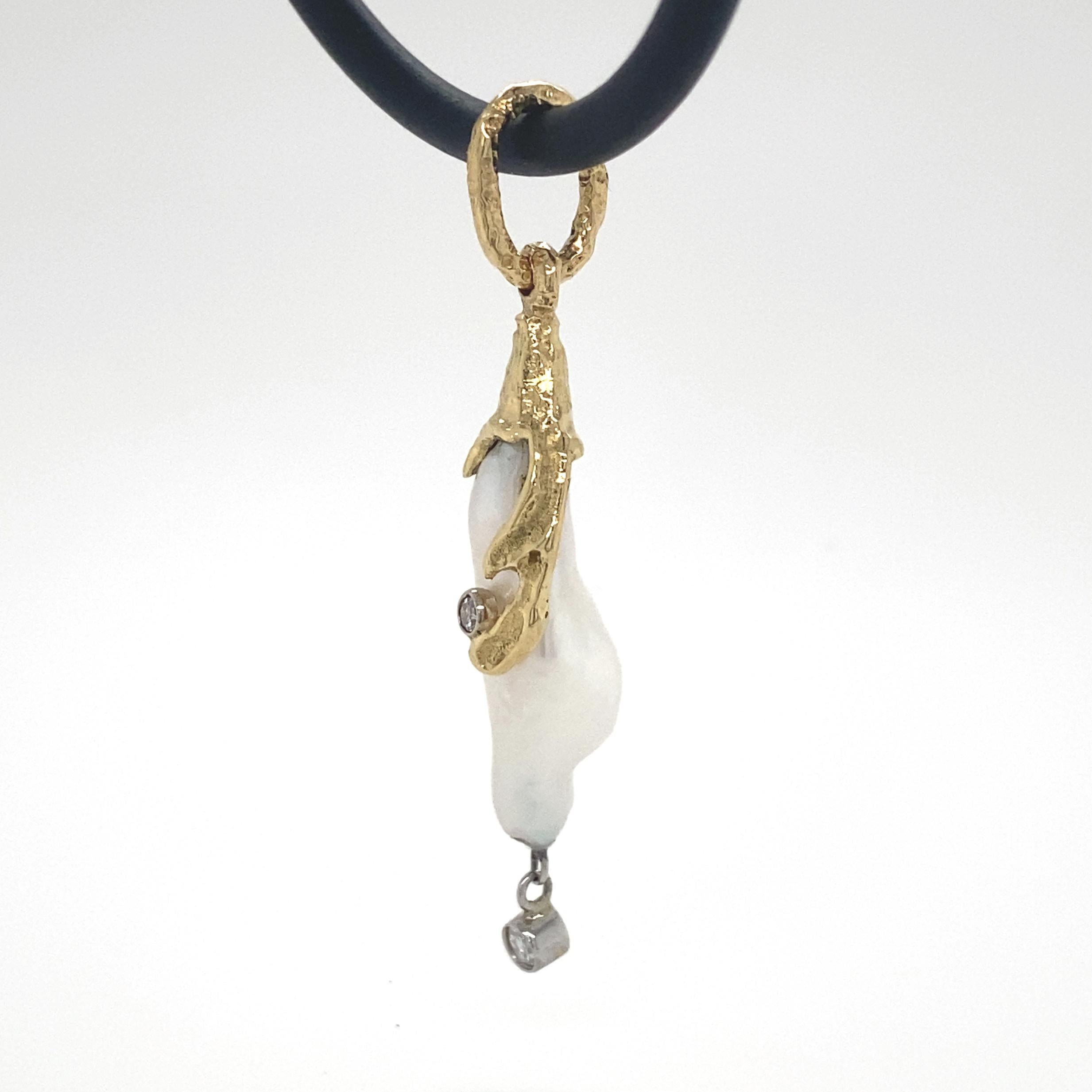 This adorable, one-of-kind pendant, with its funny little bulging behind and peek-a-boo curl, reminds us of the 1920's flapper cartoon character Betty Boop.  Eytan Brandes made it on a whim, spotting the pearl in a pile of baroques we were sorting