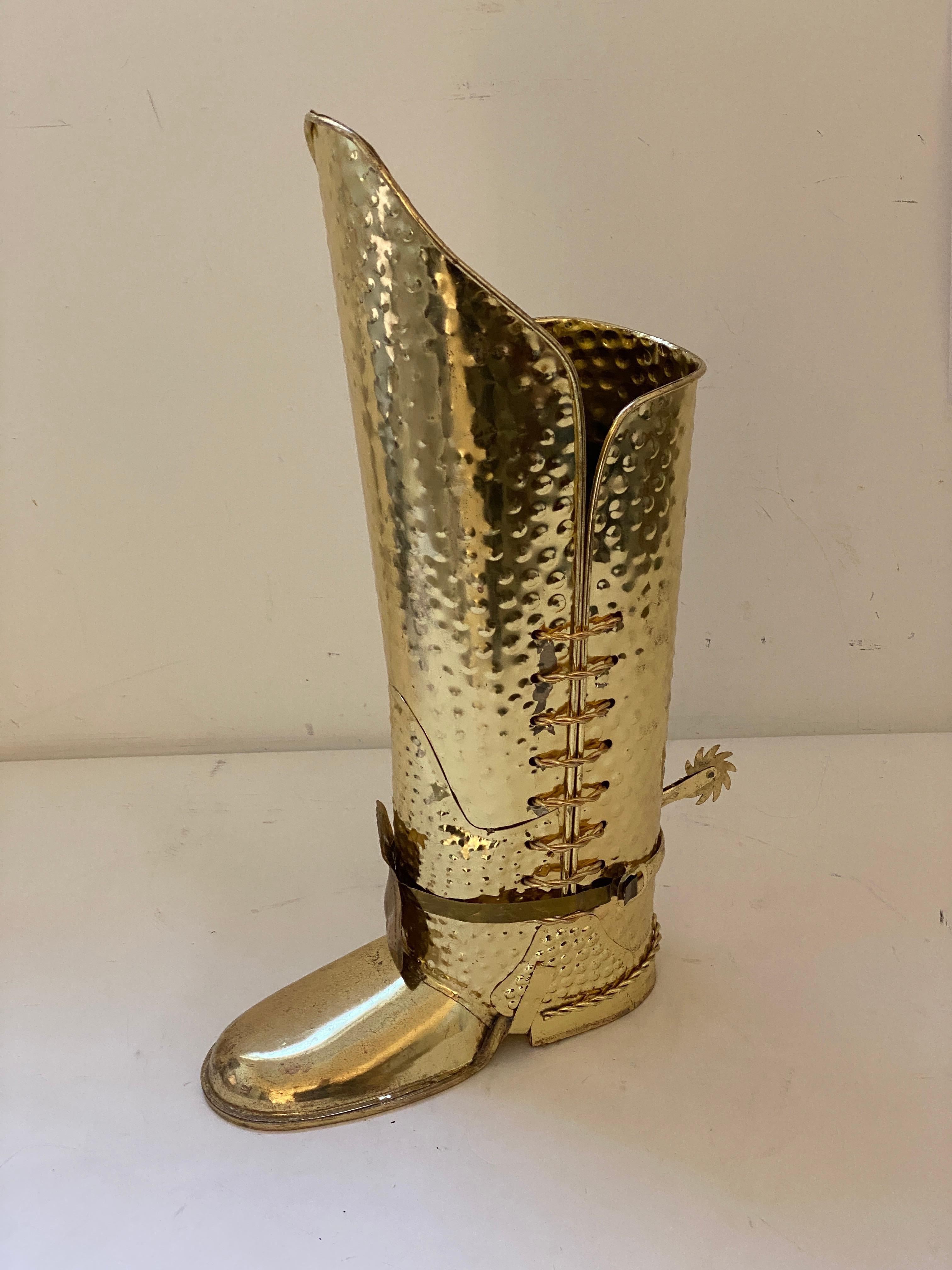 This stylish and chic boot-form umbrella holder dates to the 1970s and was created in England.

Note: The piece is fabricated in metal with a gold-tone finish.

Note: The red paper on the inside is to shield an umbrealla or cane catching on the