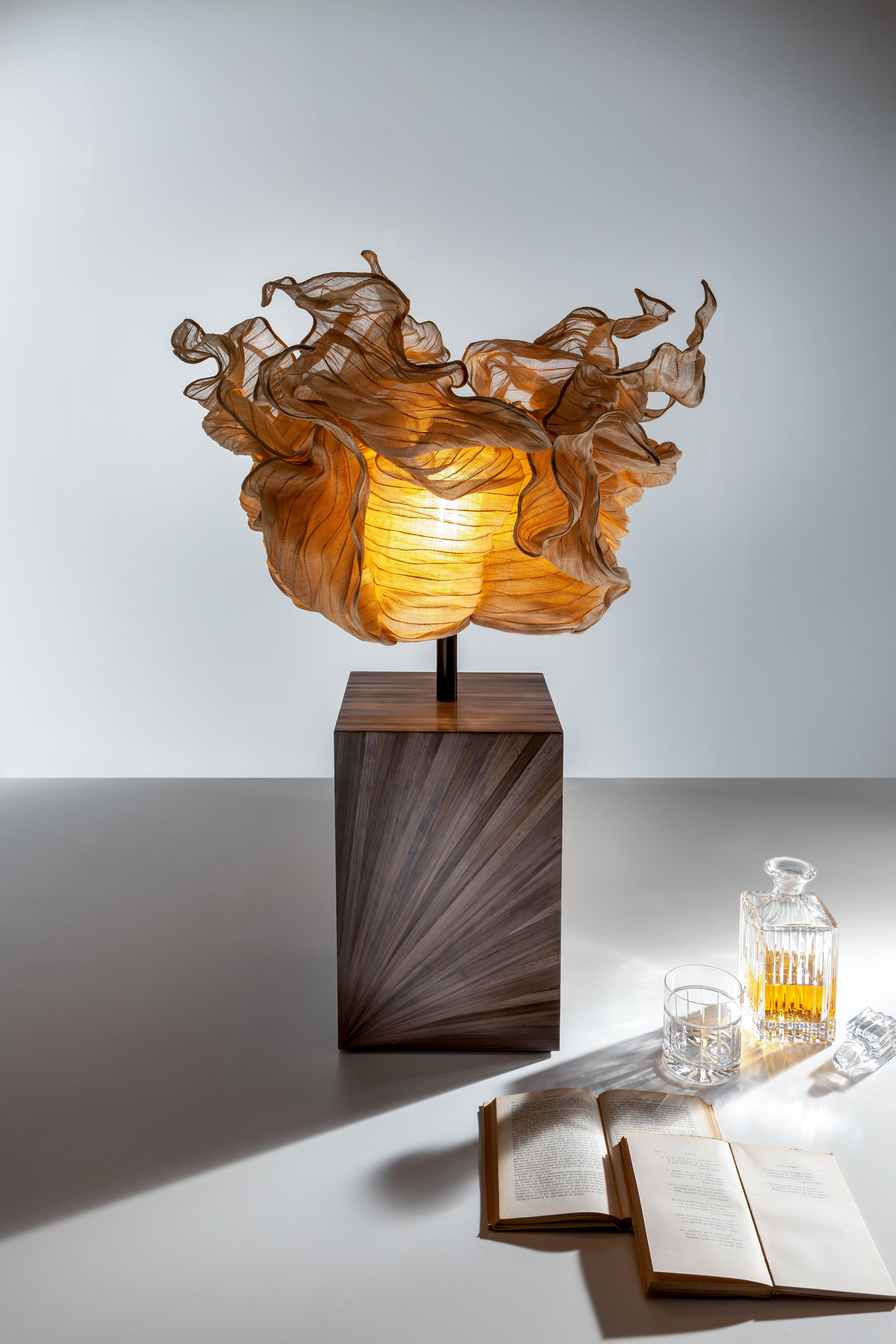 Boote Table Lamp by Laurameroni
Dimensions: W 42 x D 16 x H 52 cm
Materials: Brown rye‐straw inlay and Banaca. 

Table lamp with base covered in brown rye‐straw inlay and Banaca fiber lampshade.

Laurameroni:
The ability of craftsmen from the