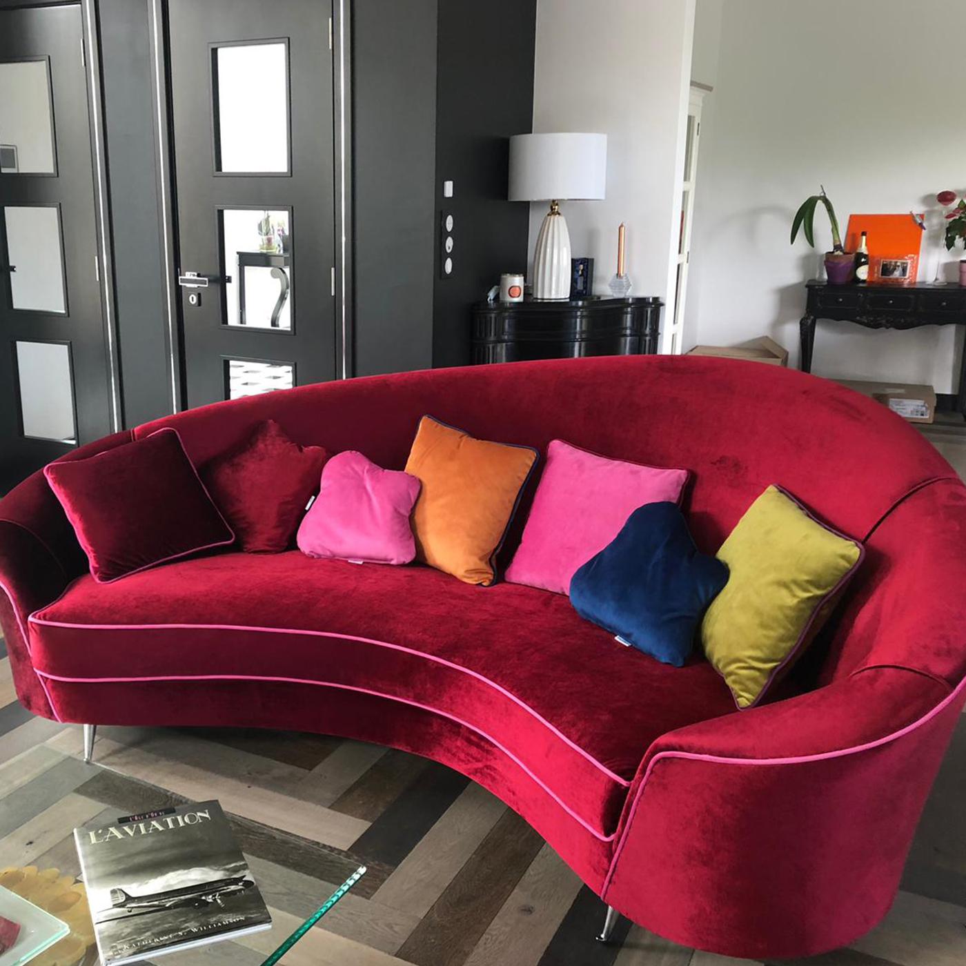 A curved sofa with an enveloping, cozy shape. The Bora Bora sofa has a solid wood structure covered in velvet and the colors are chosen by the customer. It is possible to remove only the seat cushion and the 4 sofa pillows. Perfect for any domestic