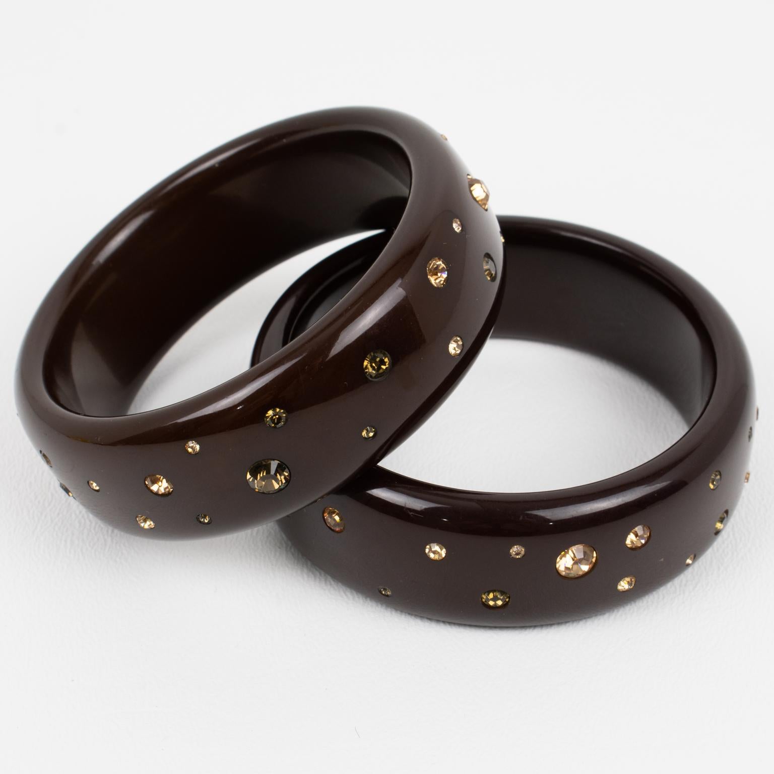 These outstanding Borbonese, Italy Lucite bracelet bangles feature a domed shape in cocoa brown color. The bangles are ornate with light topaz and smoke-brown crystal rhinestones randomly hand-setted. Both bracelets are marked with the engraved