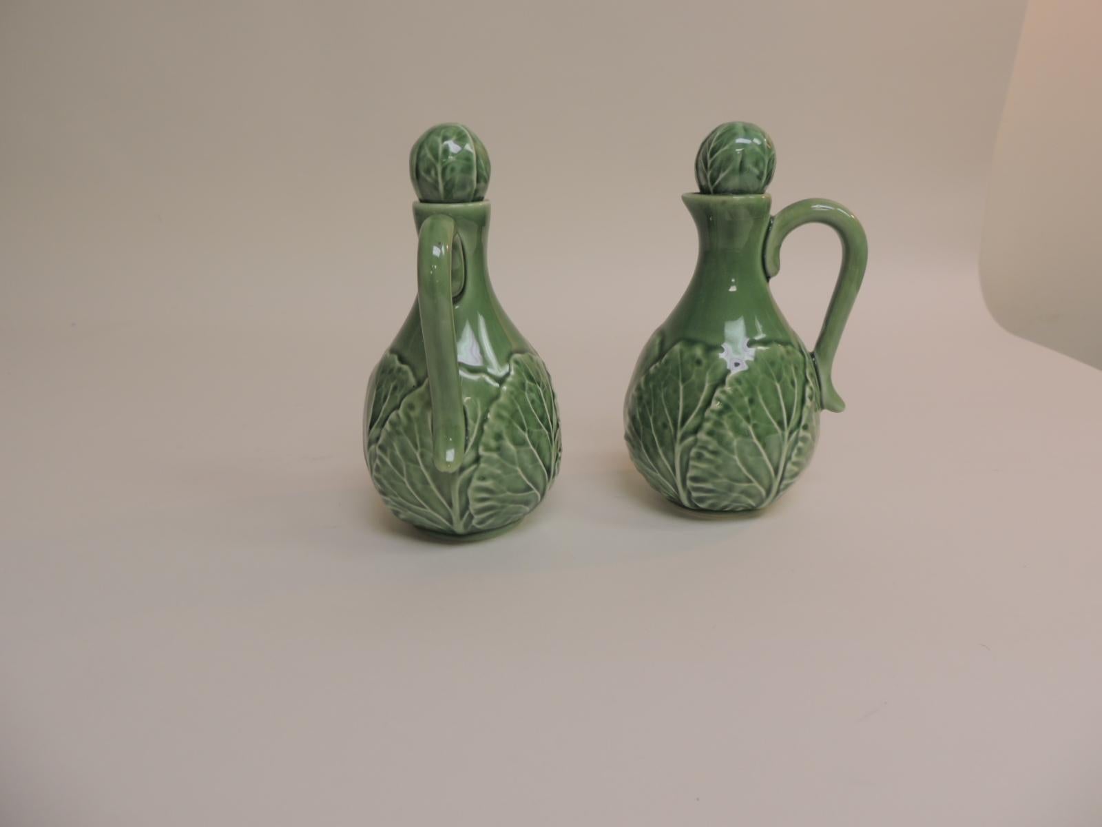 Bordalo Pinhero vintage pair of green cabbage leaves salad dressing holders.
Bordalo Pinheiro Cruet salad set in green. Vintage decorative oil and vinegar holders in perfect condition and signed by the Portuguese artist and cartoonist. Stoppers and