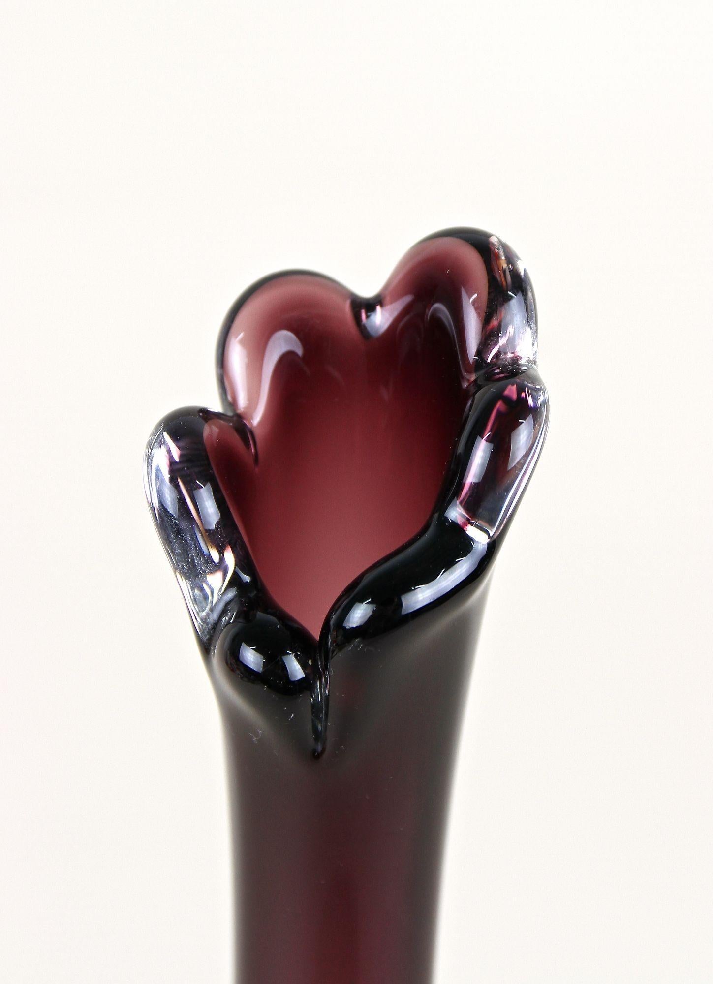Elegant, bordeaux red Murano glass vase coming from the famous workshops of the little island in Venice. Artfully handcrafted in the late 20th Century around 1970, this beautiful Murano vase impresses with an absolute timeless design: a bulbous,