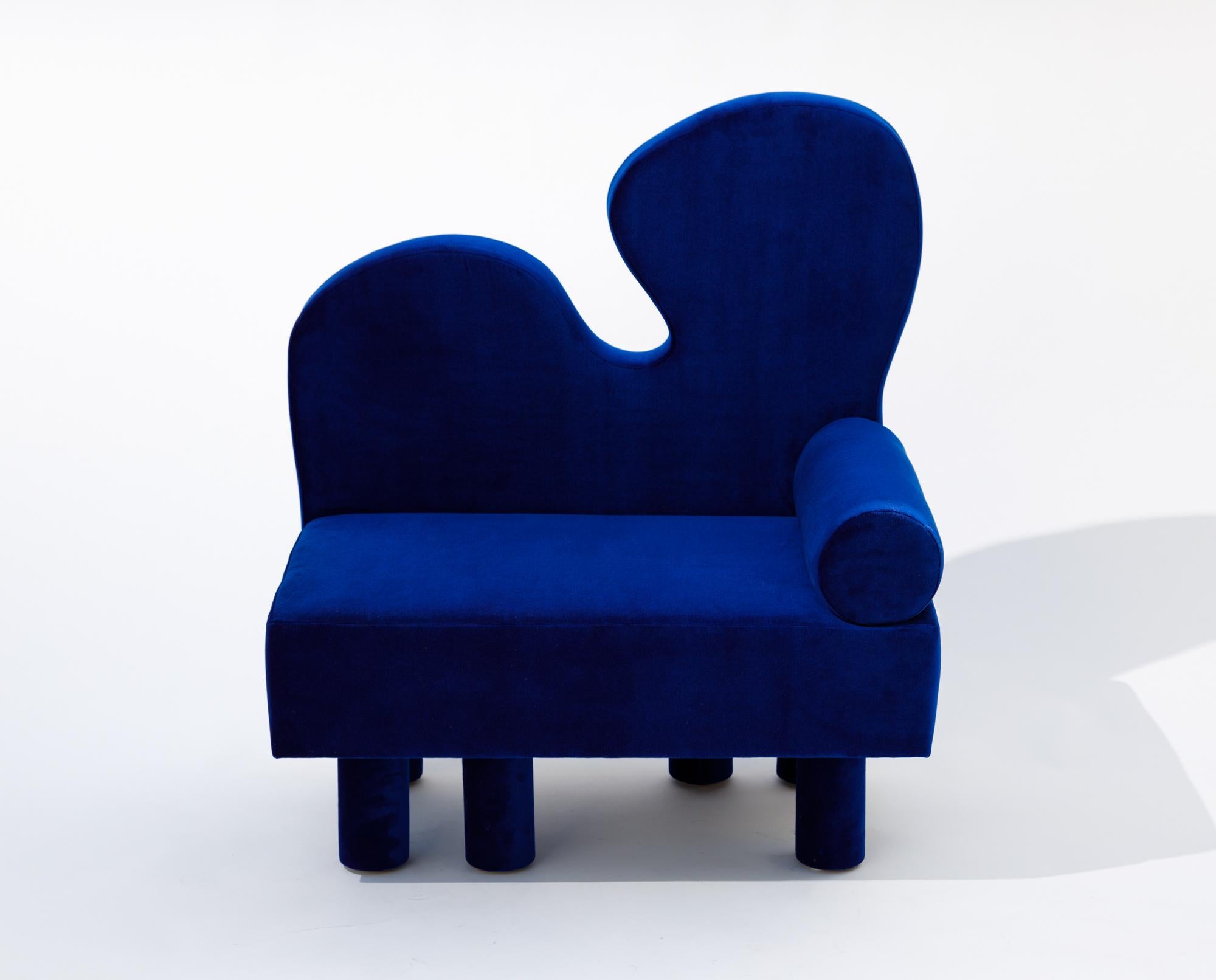 With Bordon, an oversized chair upholstered in a vibrant blue velvet, another human explores fantastical shapes reminiscent of Matisse while creating a dreamlike creature, complete with six chunky legs offset in their placement, creating the feeling