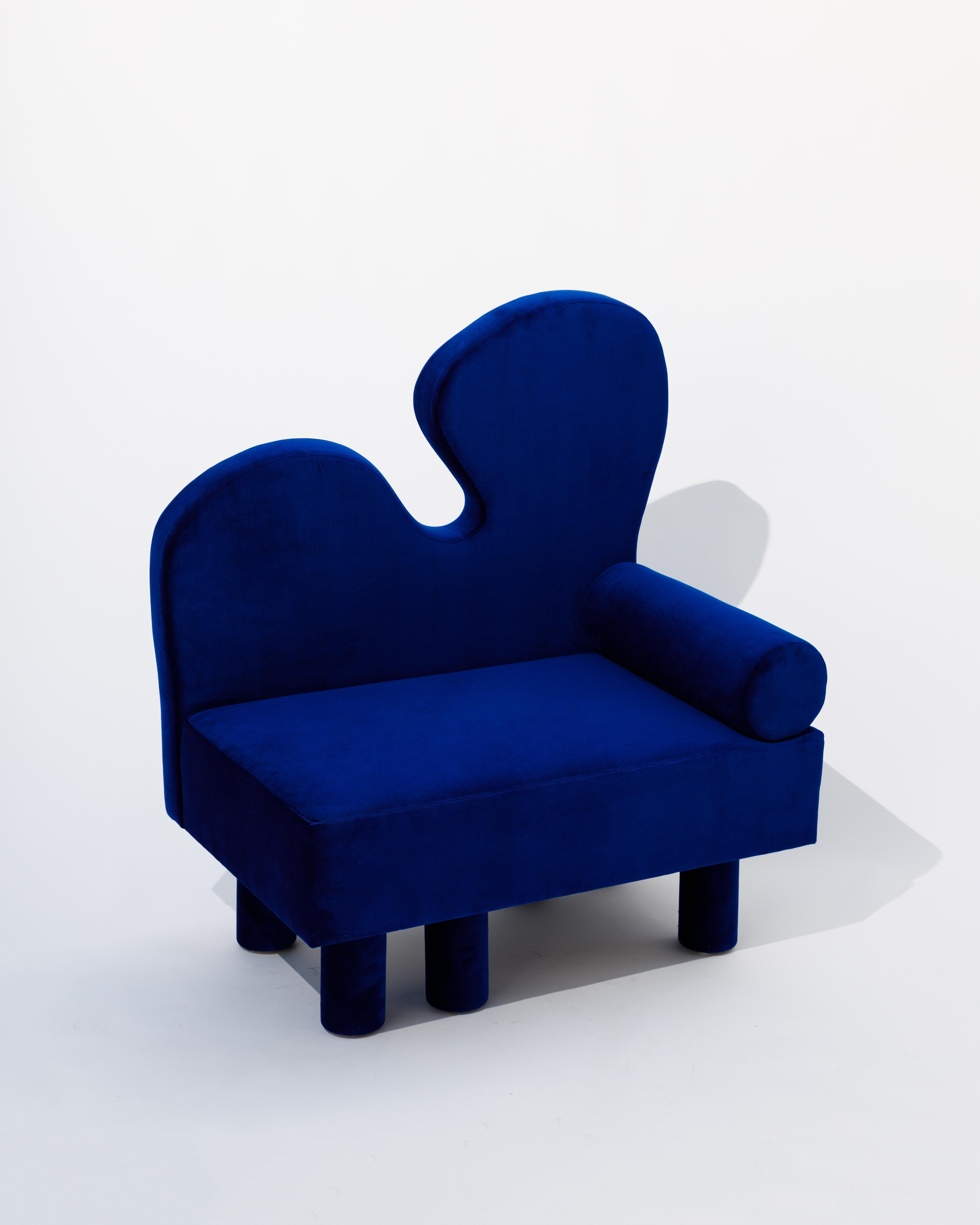 With Bordon, an oversized chair upholstered in a vibrant blue velvet, another human explores fantastical shapes reminiscent of Matisse while creating a dreamlike creature, complete with six chunky legs offset in their placement, creating the feeling