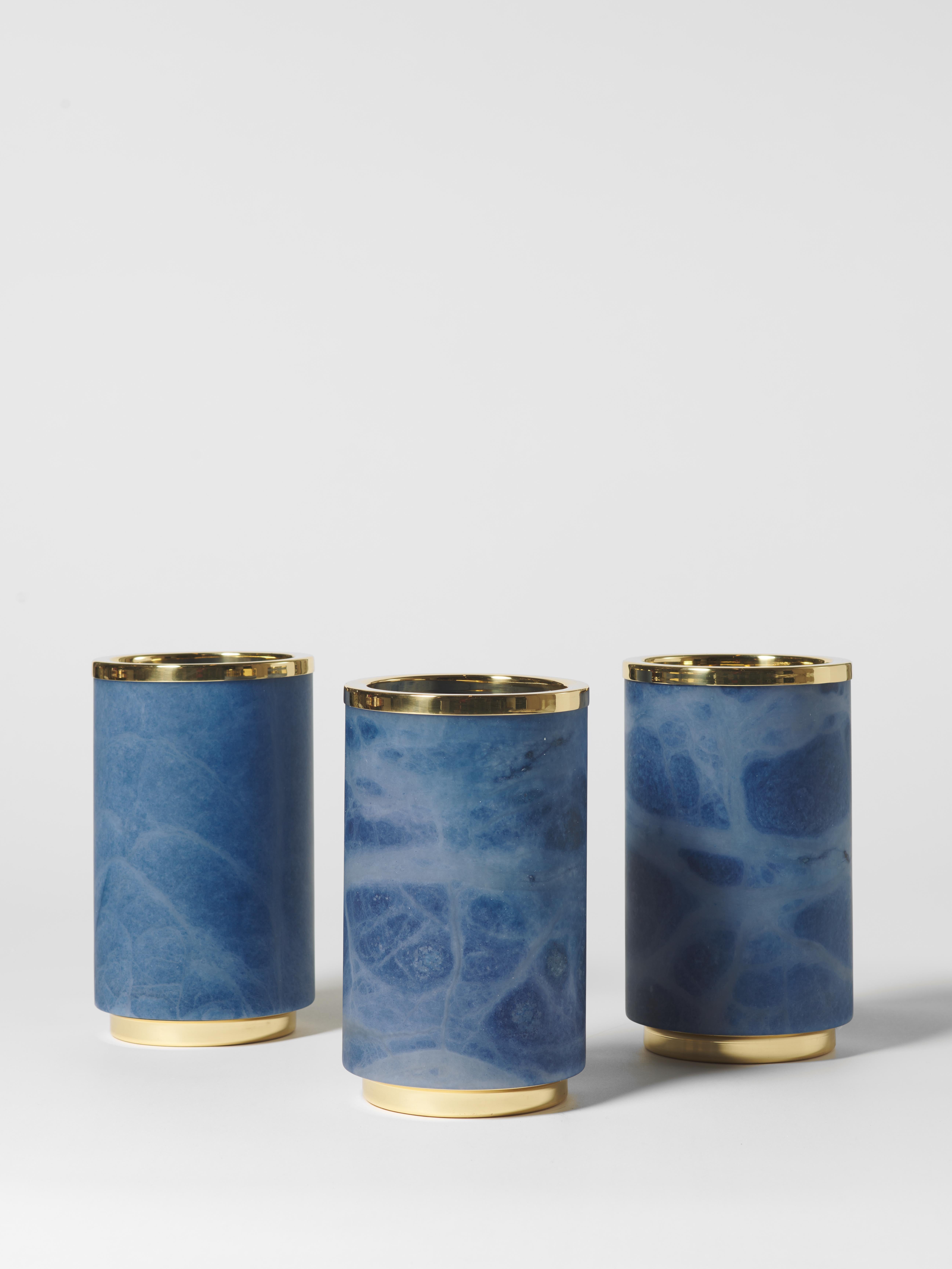 This exquisite vase combines the timeless beauty of blue alabaster with the refined touch of polished brass. Its cylindrical shape enhances its minimalist elegance, making it a sophisticated addition to any interior. The natural veining of the